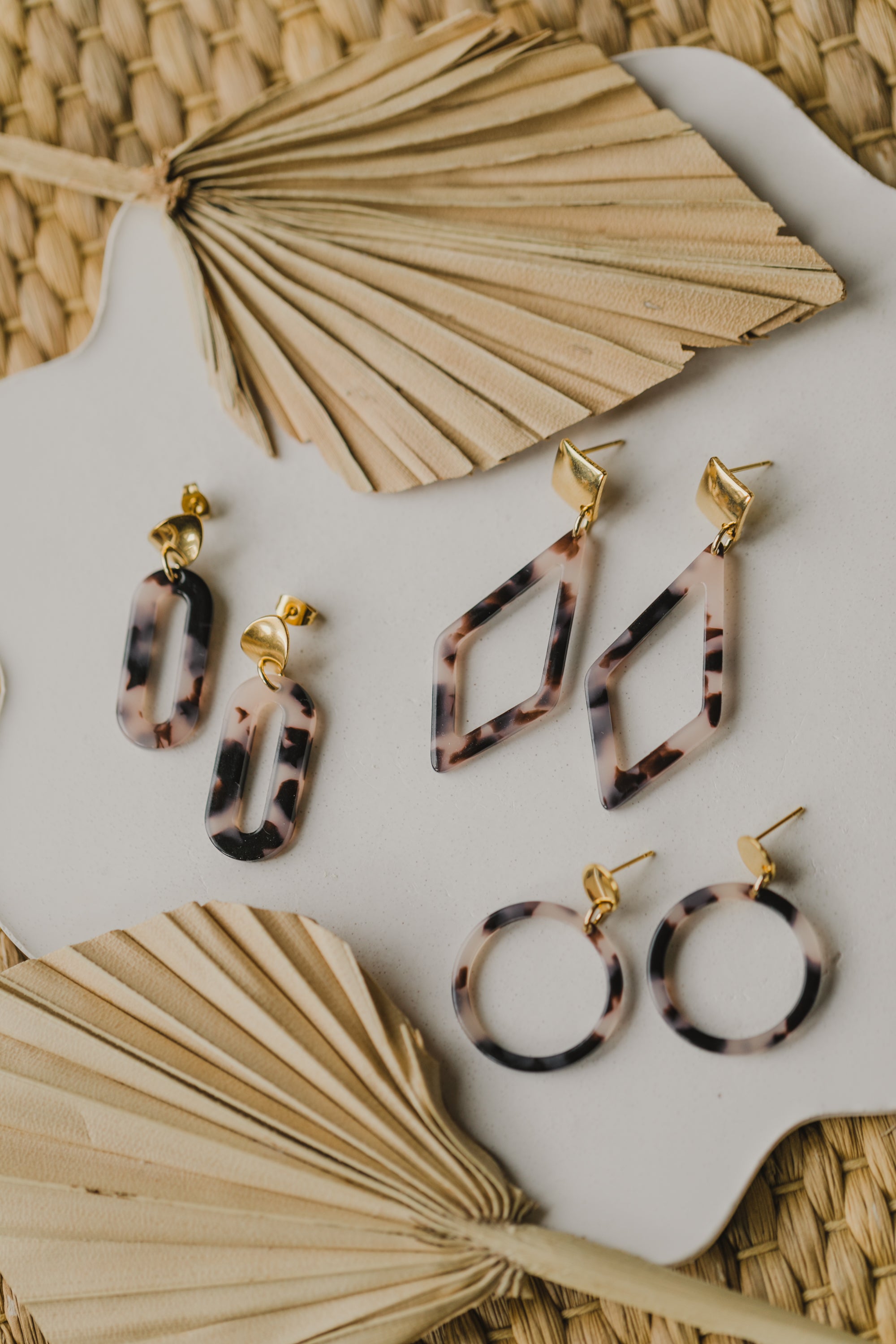 golden earrings with acrylic in white, petrol and brown