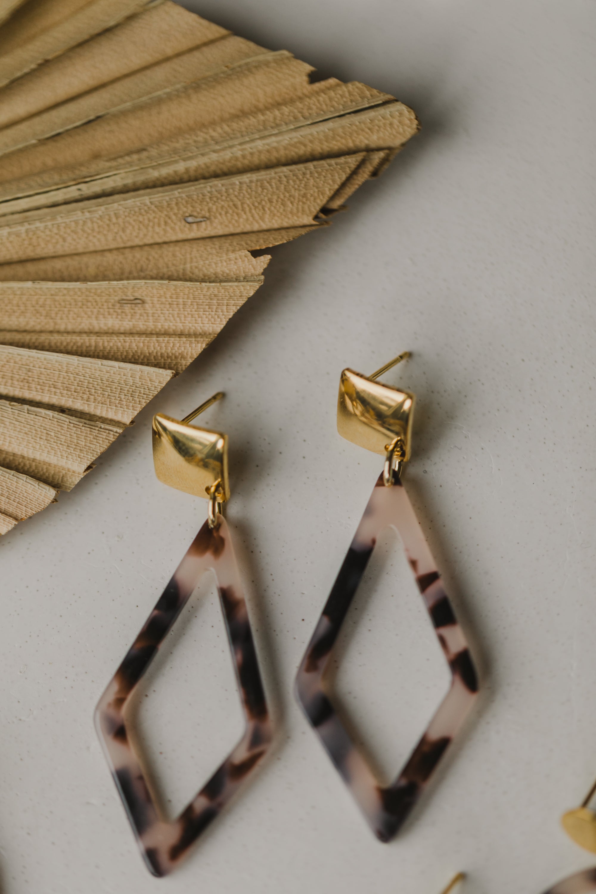 golden earrings with acrylic in white, petrol and brown