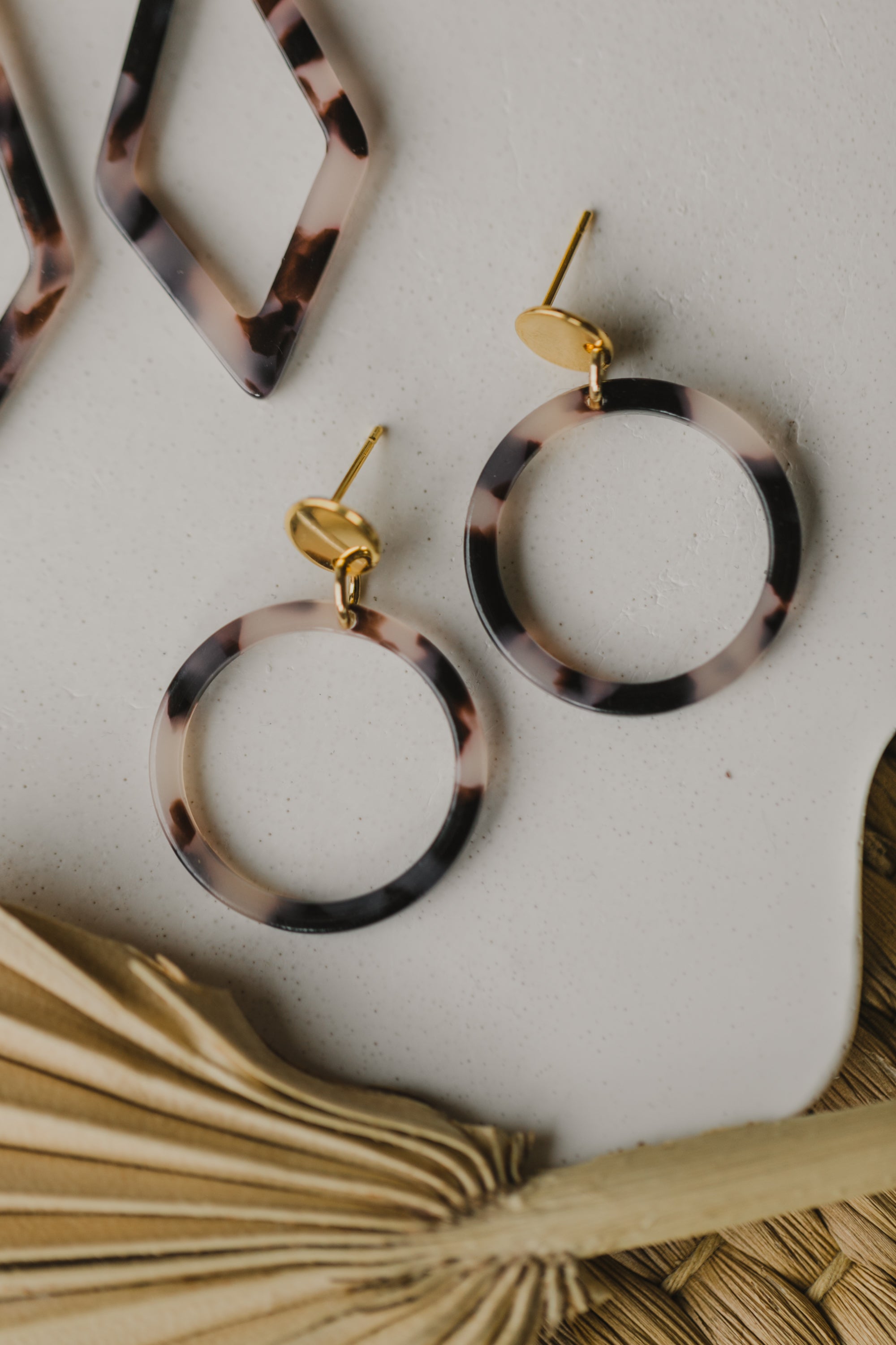golden earrings with acrylic in white, petrol and brown