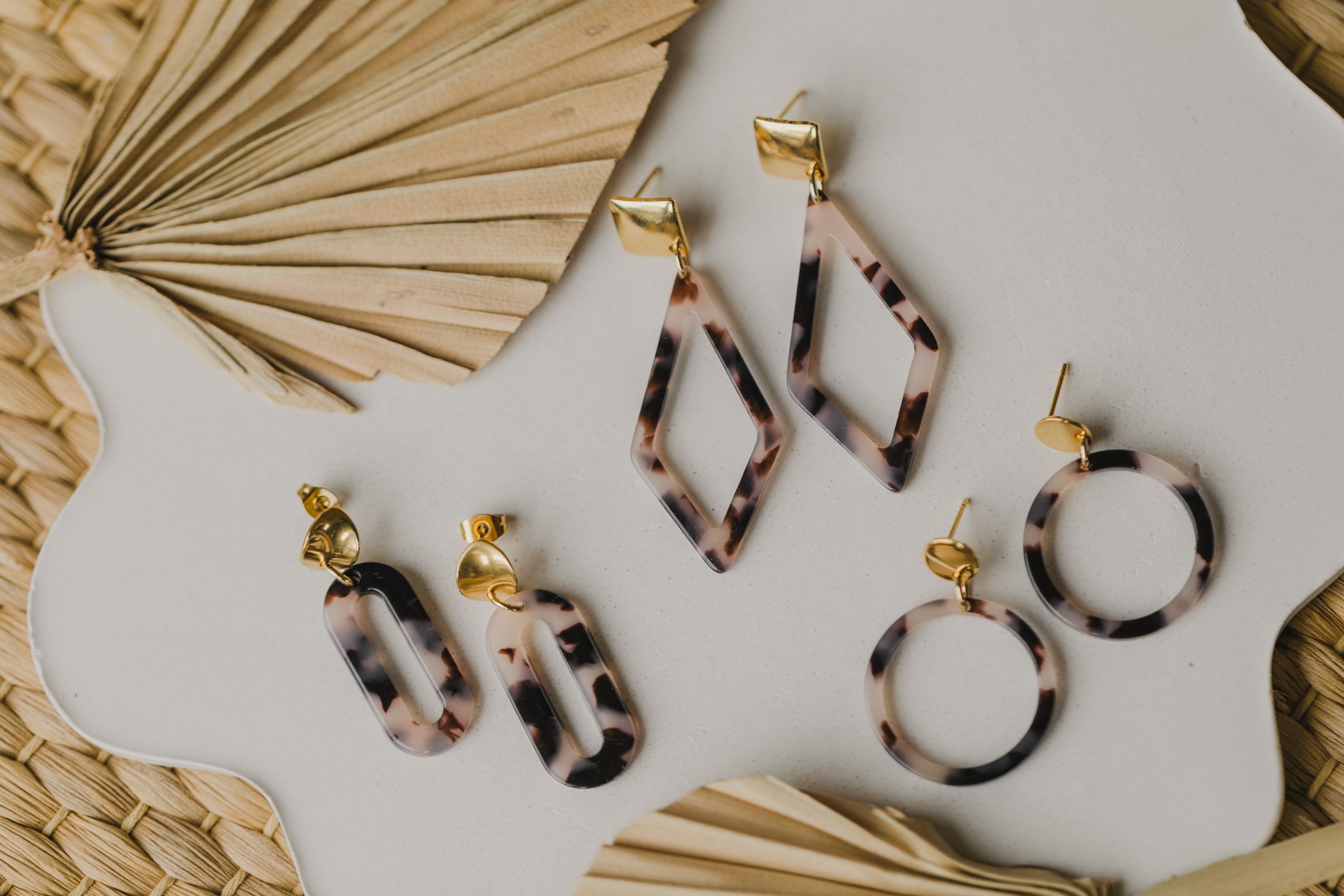 golden earrings with acrylic in white, petrol and brown