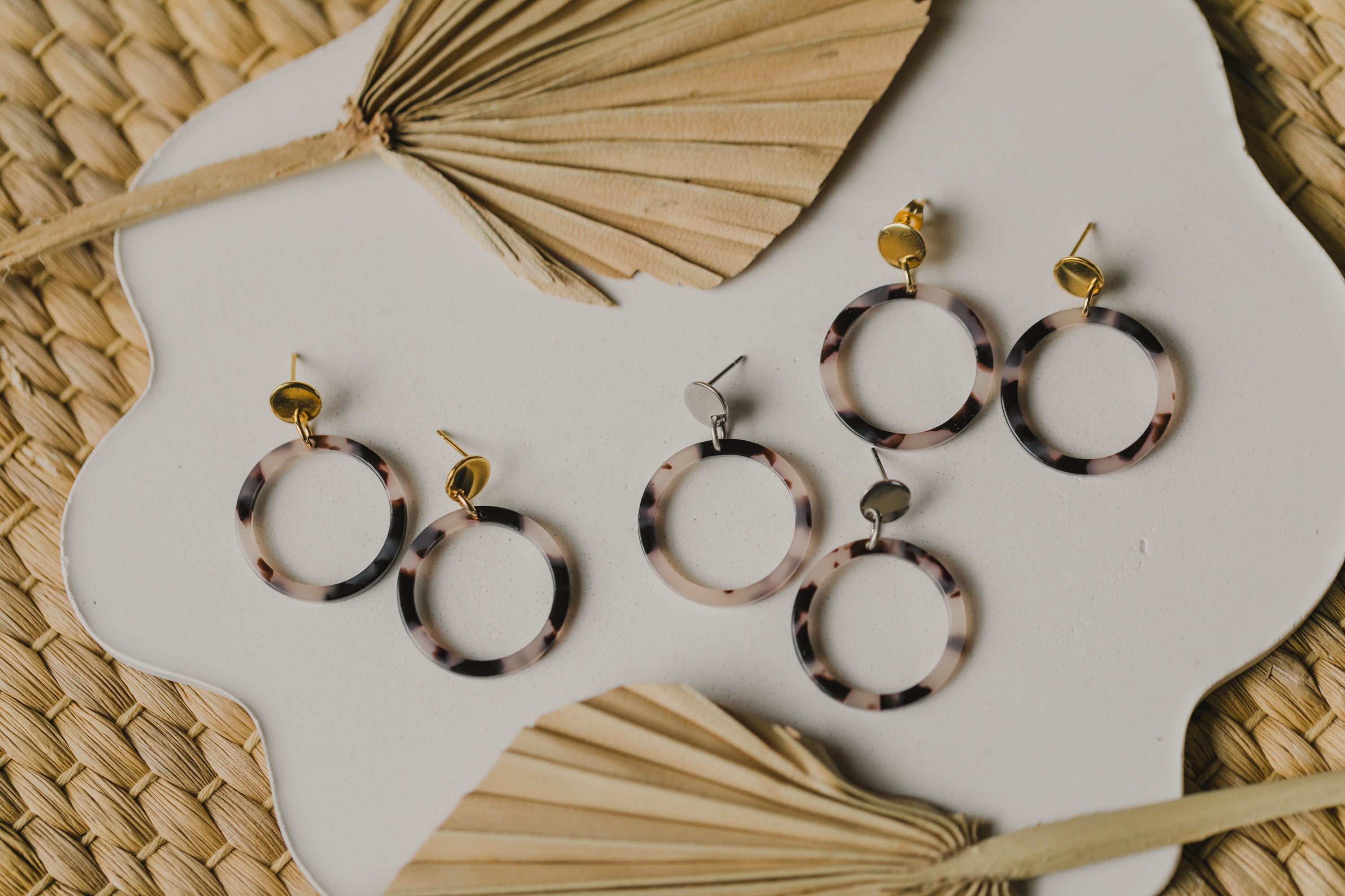 golden earrings with acrylic in white, petrol and brown