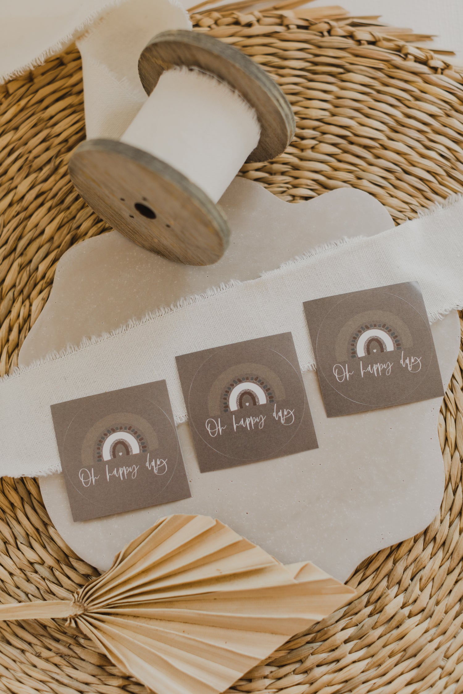 runde braune Aufkleber mit der Aufschrift "Oh happy day" und Regenbogen