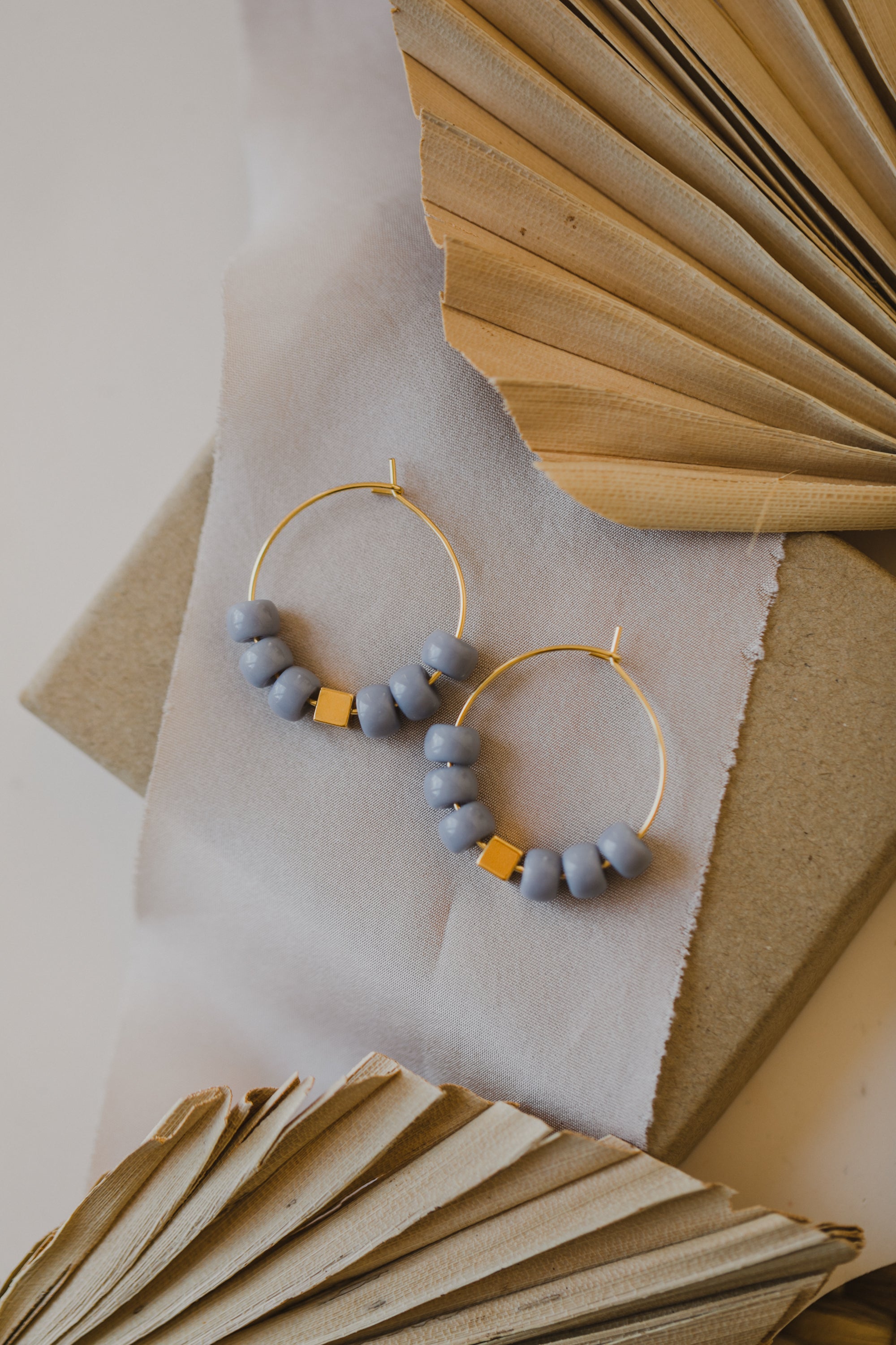 filigree creole made of titanium with blue ceramic beads