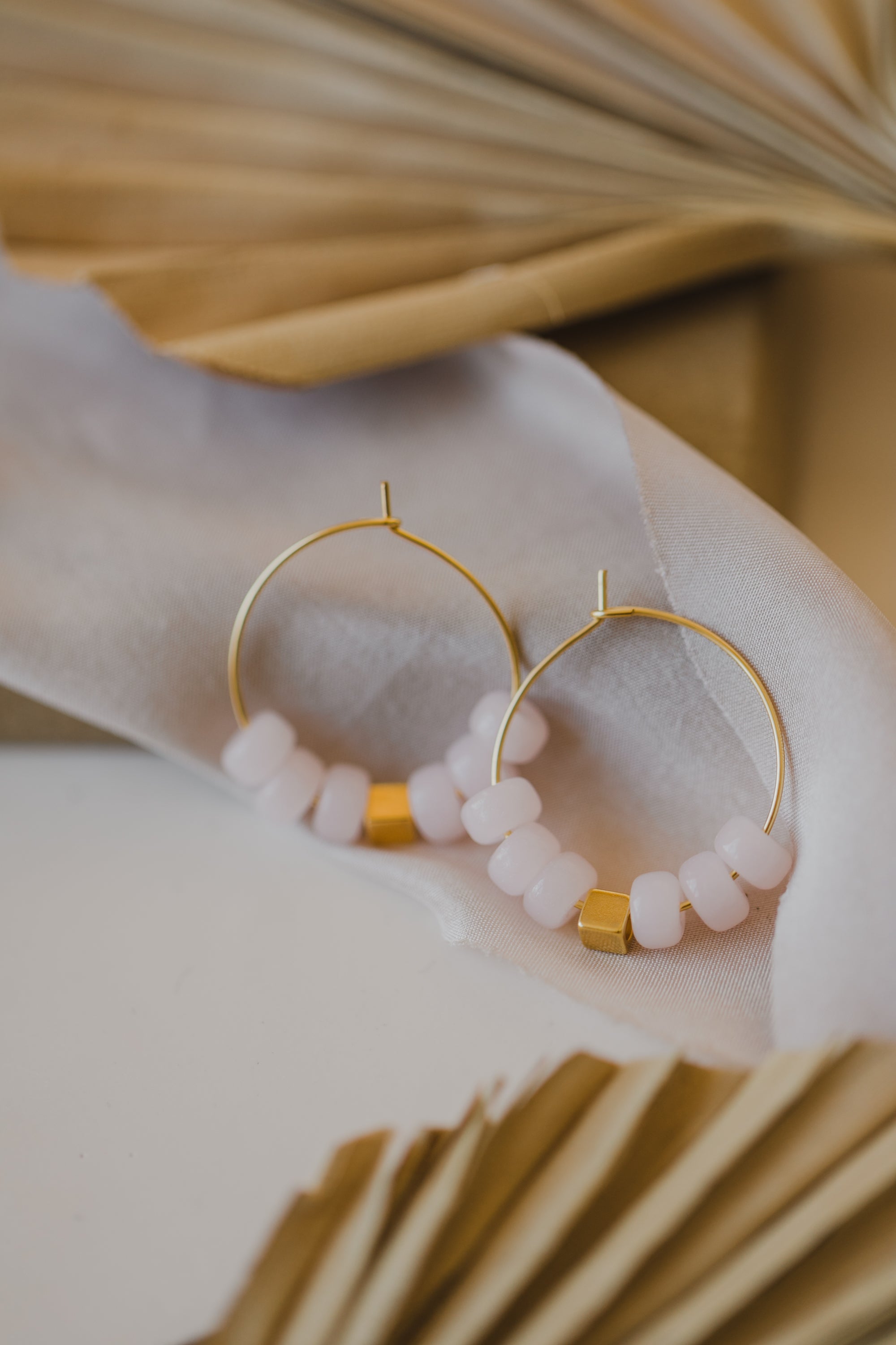 filigree creole made of titanium with pink ceramic beads