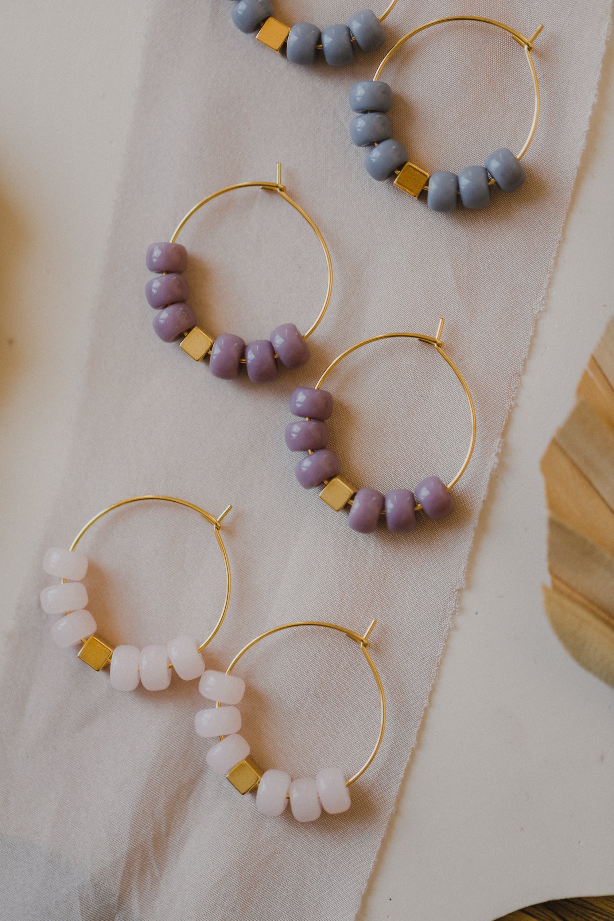 filigree creole made of titanium with pink ceramic beads