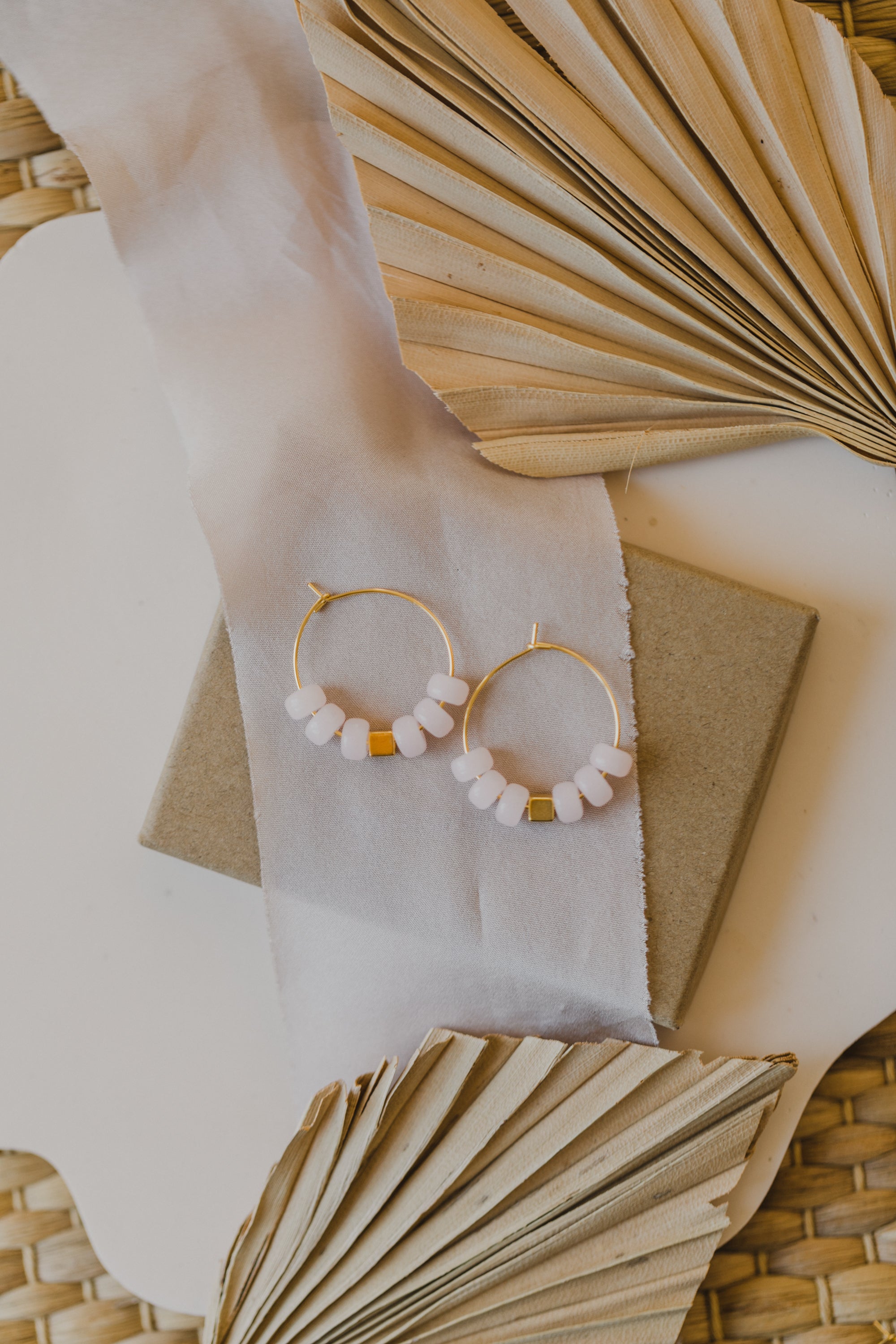 filigree creole made of titanium with pink ceramic beads