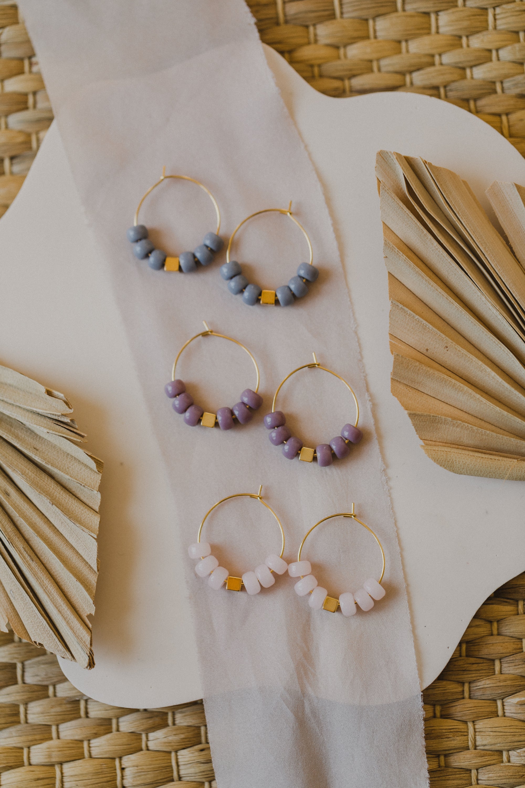 filigree creole made of titanium with purple ceramic beads