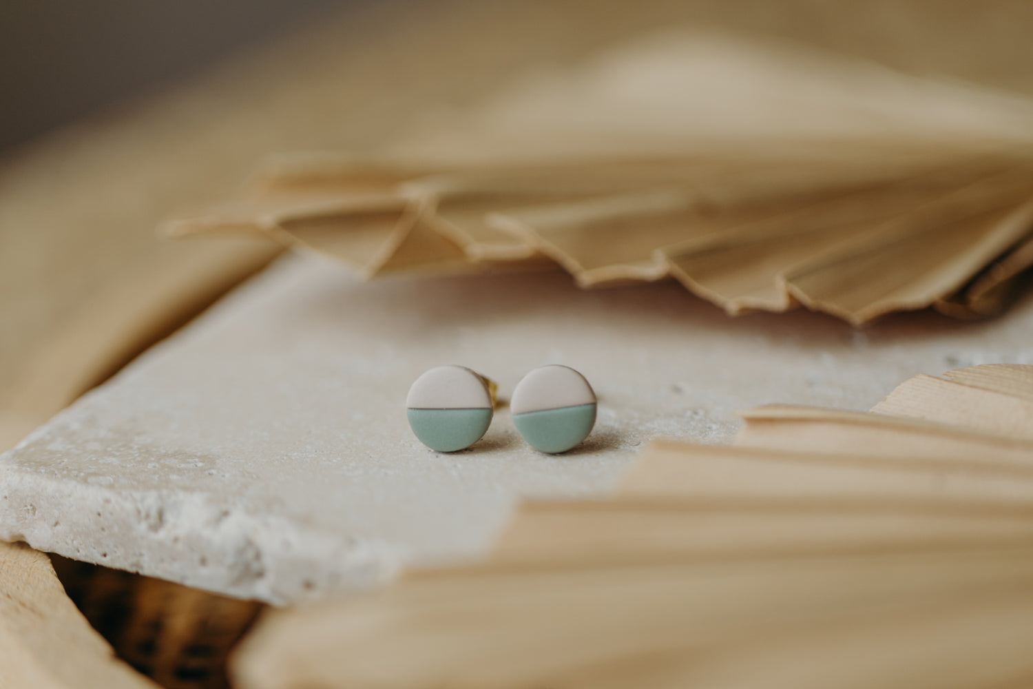 small round two-tone earrings made of polymer clay in pastel colors