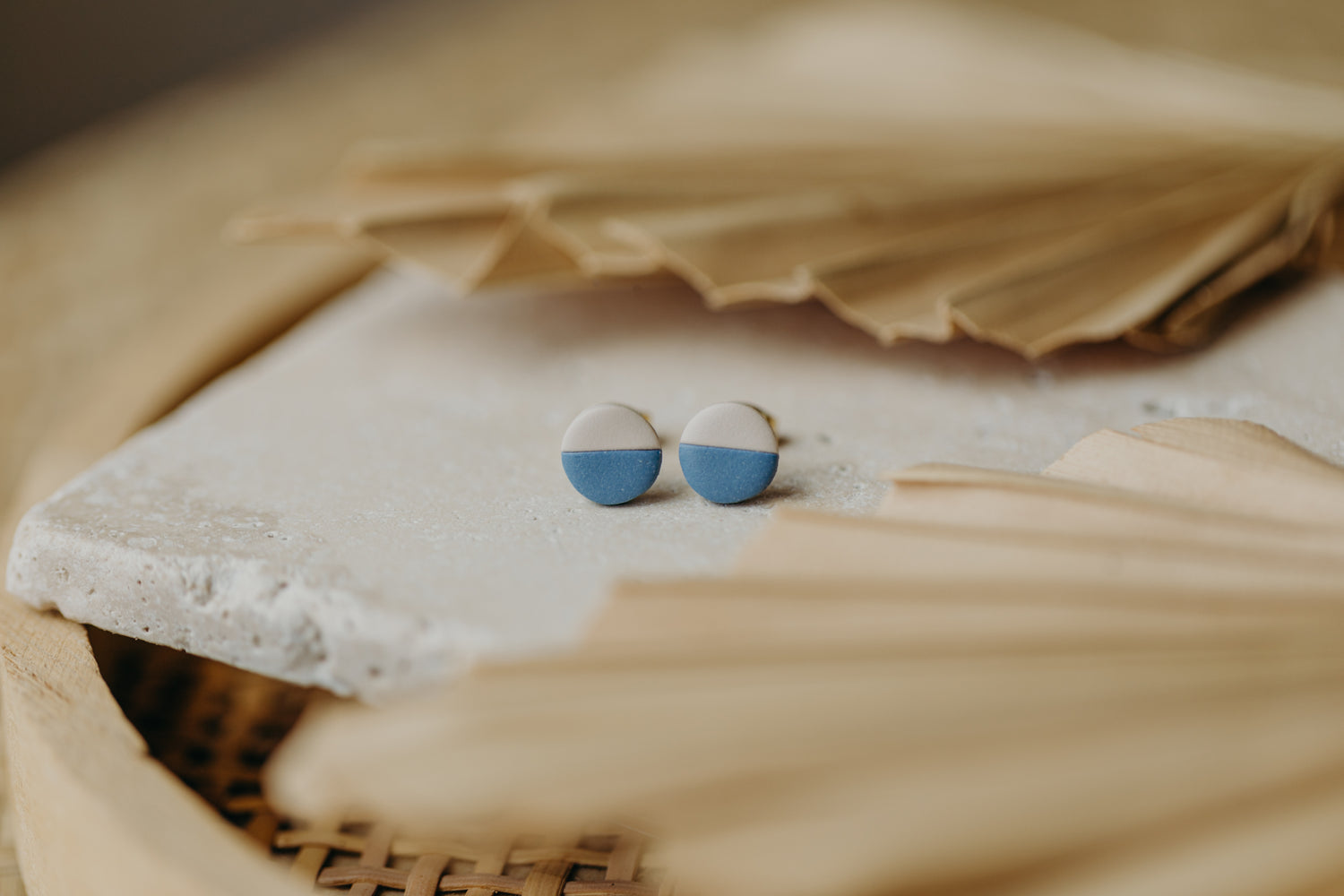 small round two-tone earrings made of polymer clay in pastel colors