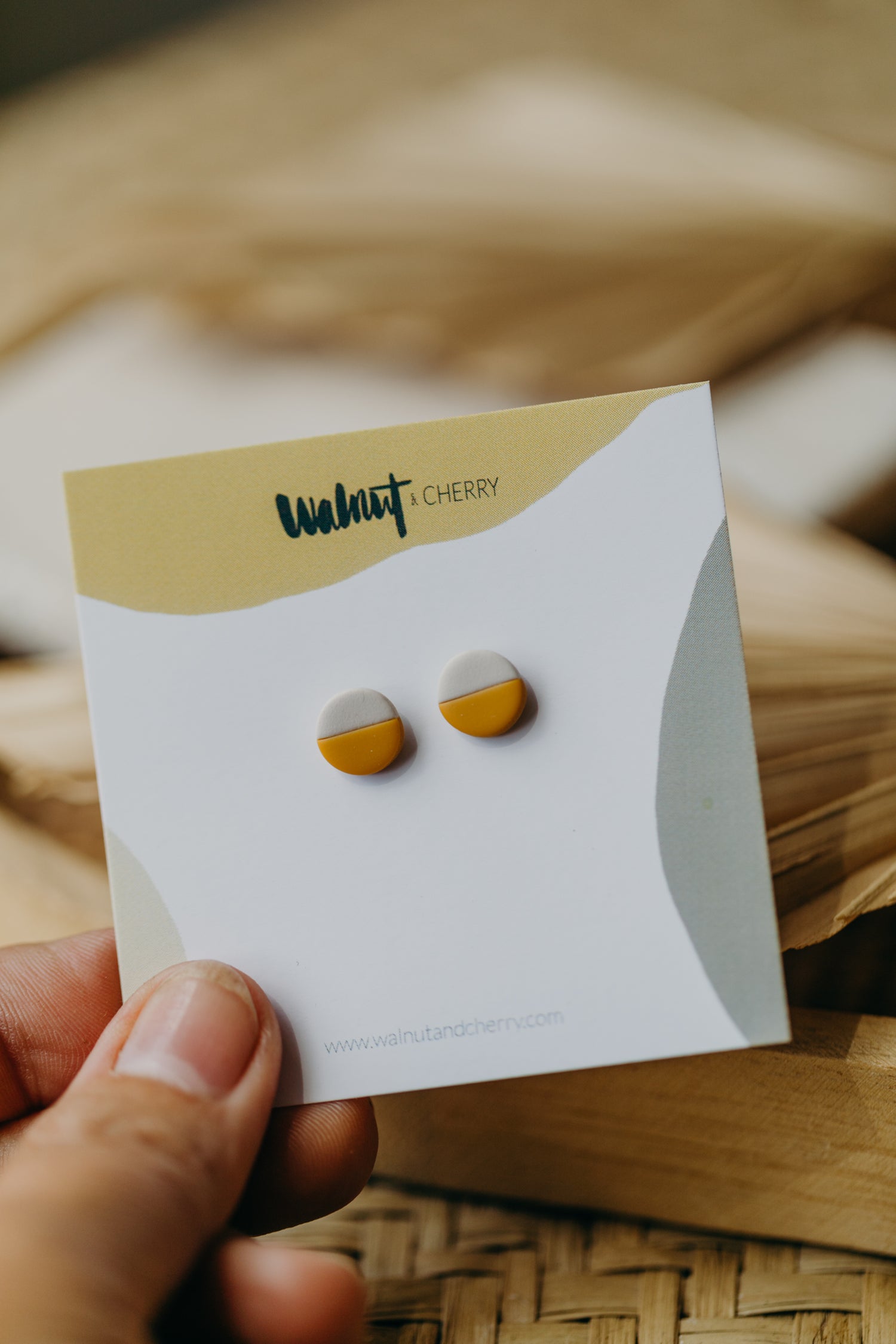 small round two-tone earrings made of polymer clay in pastel colors