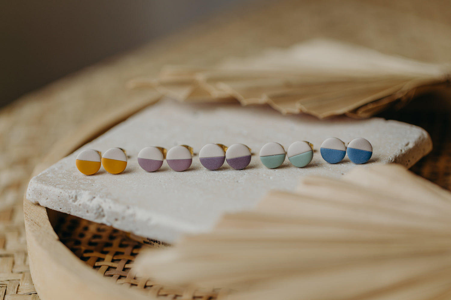 small round two-tone earrings made of polymer clay in pastel colors