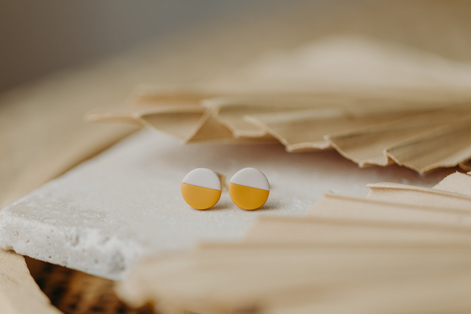 small round two-tone earrings made of polymer clay in pastel colors