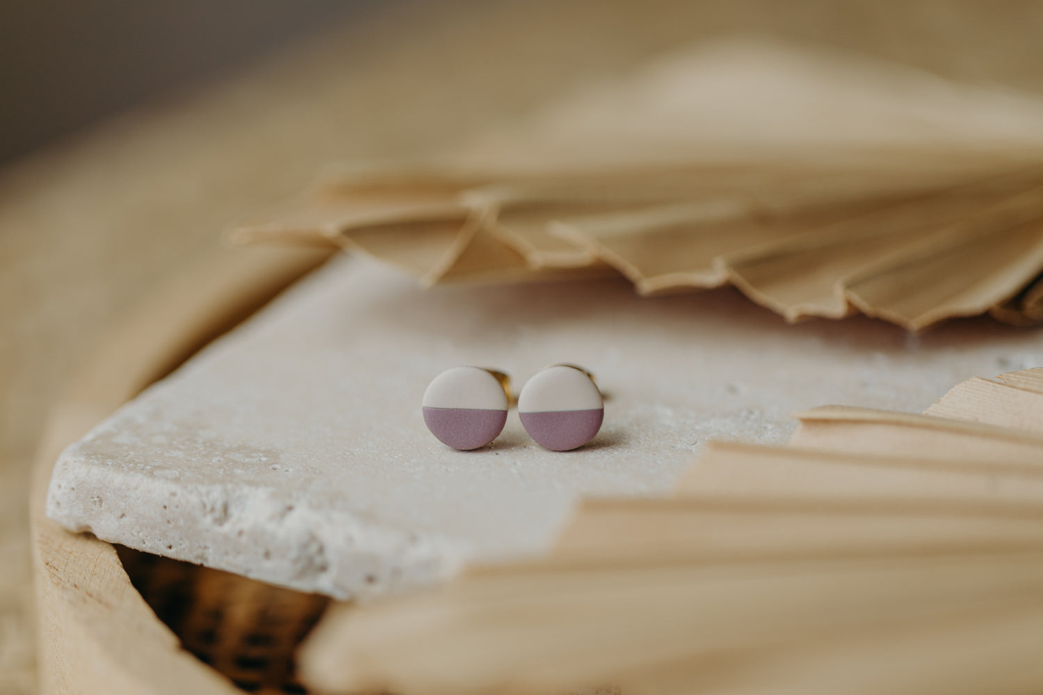 small round two-tone earrings made of polymer clay in pastel colors
