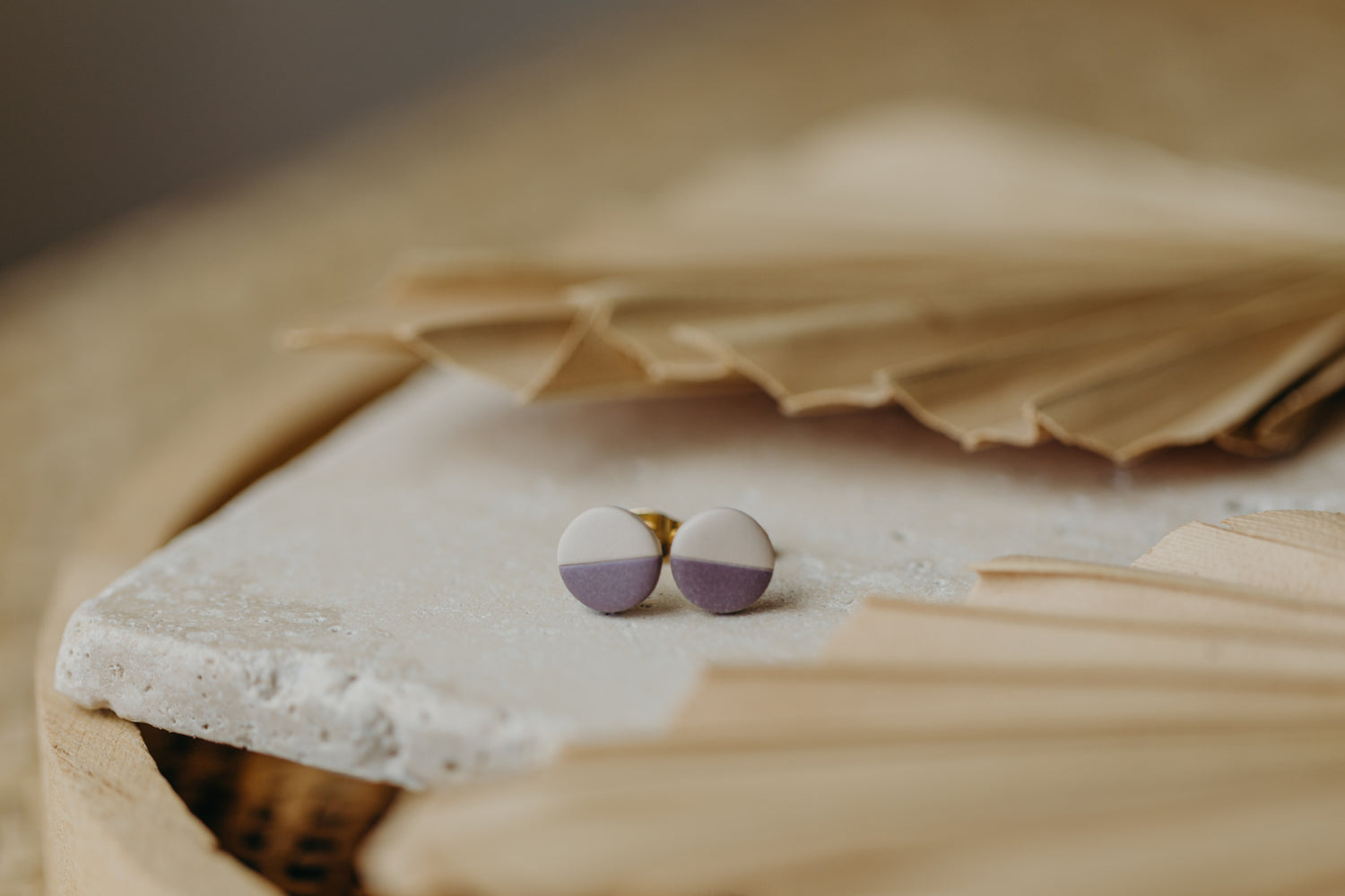 small round two-tone earrings made of polymer clay in pastel colors
