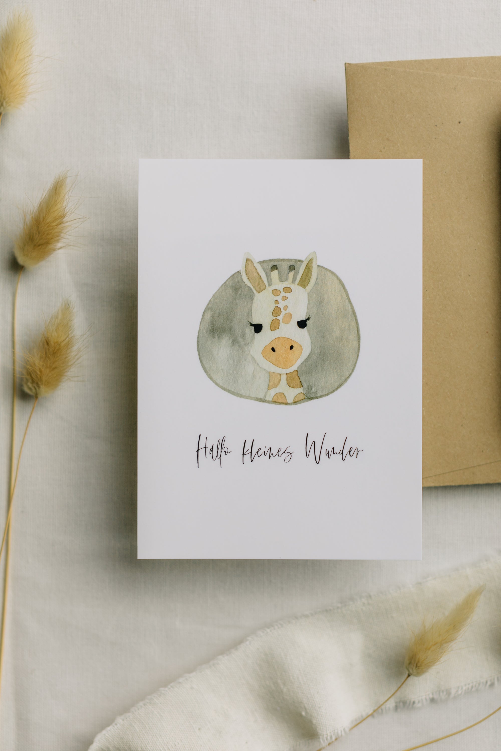 Postcard Giraffe with the print "Hello little miracle"