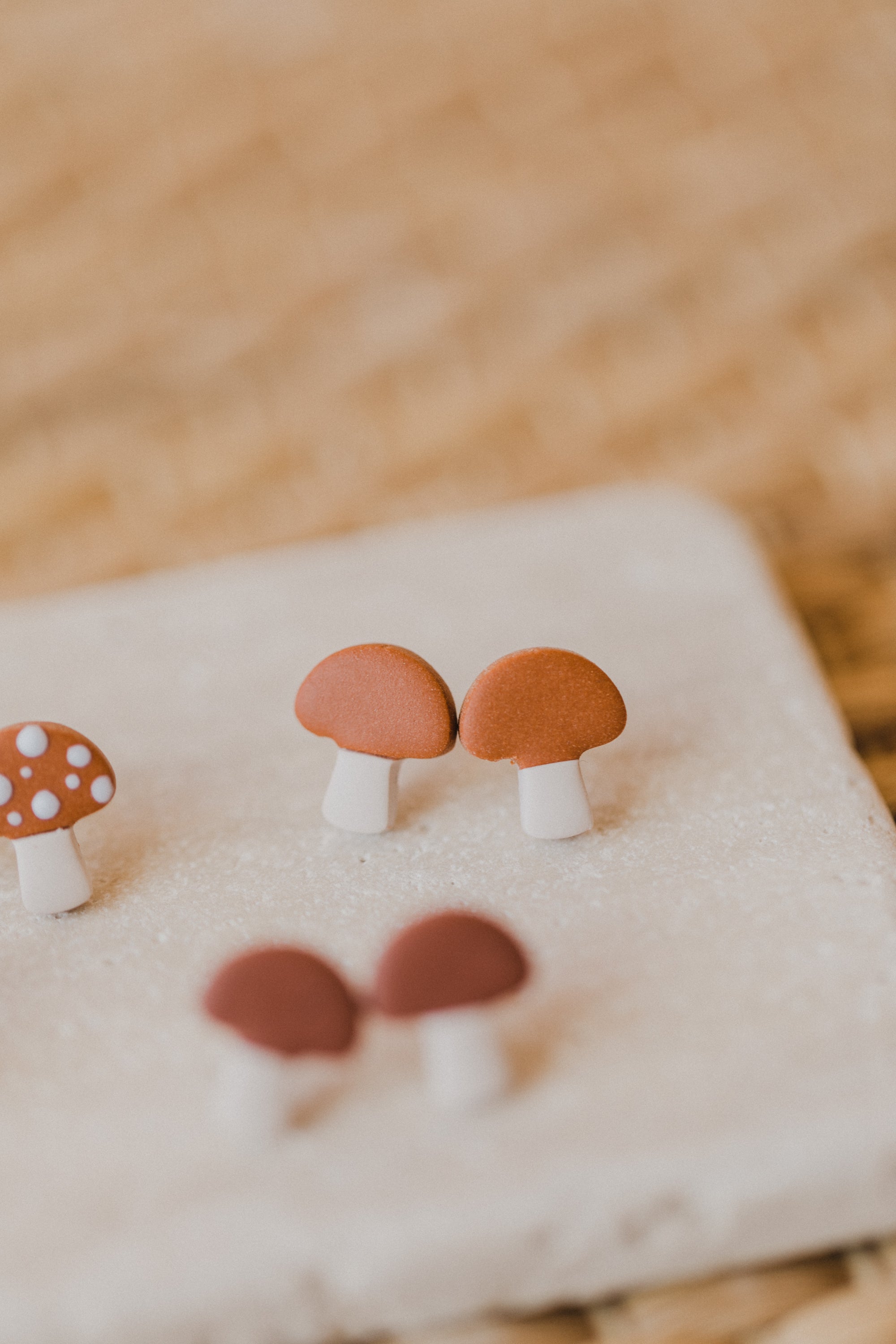 golden earrings with acrylic in white, petrol and brown