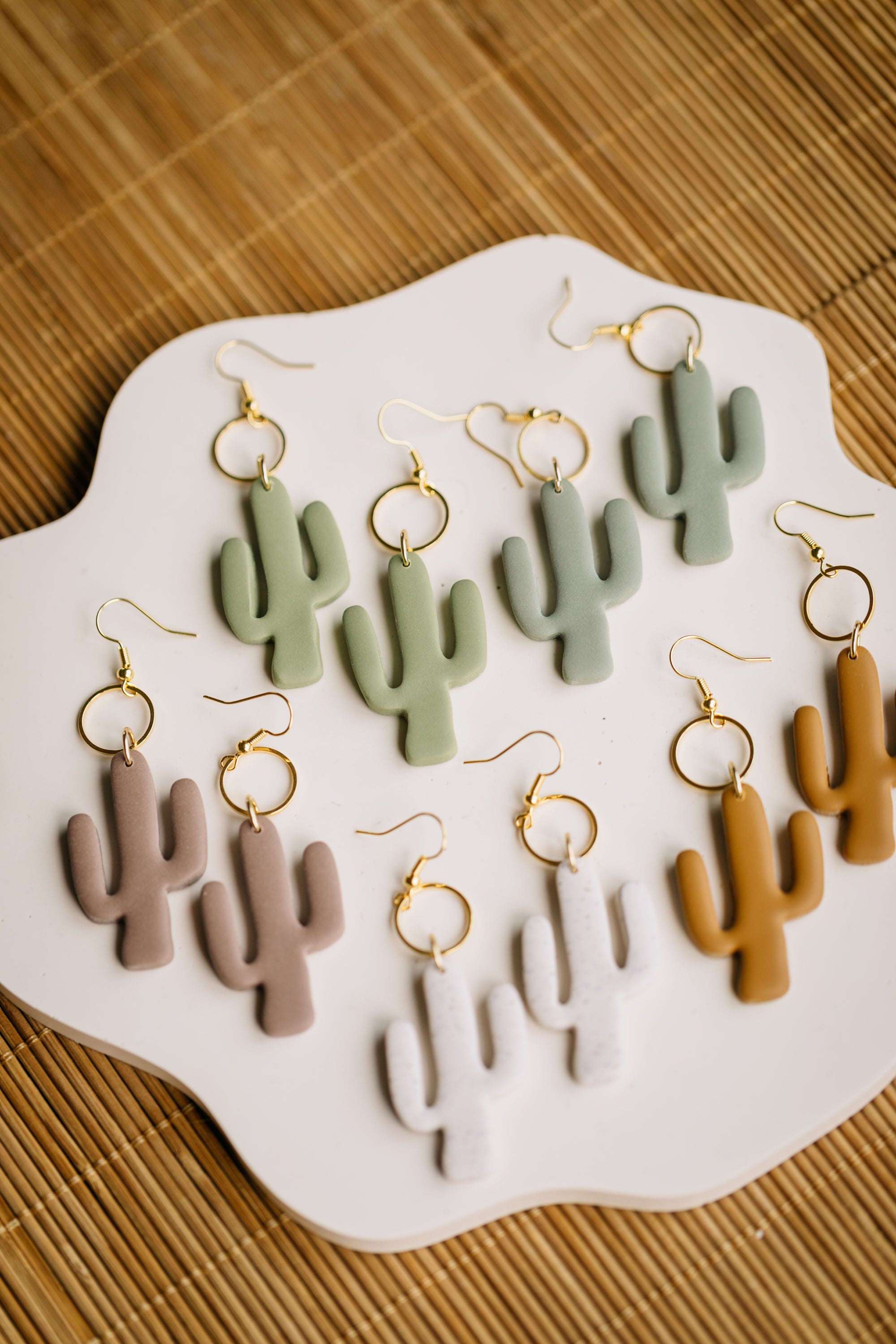 golden earrings with acrylic in white, petrol and brown