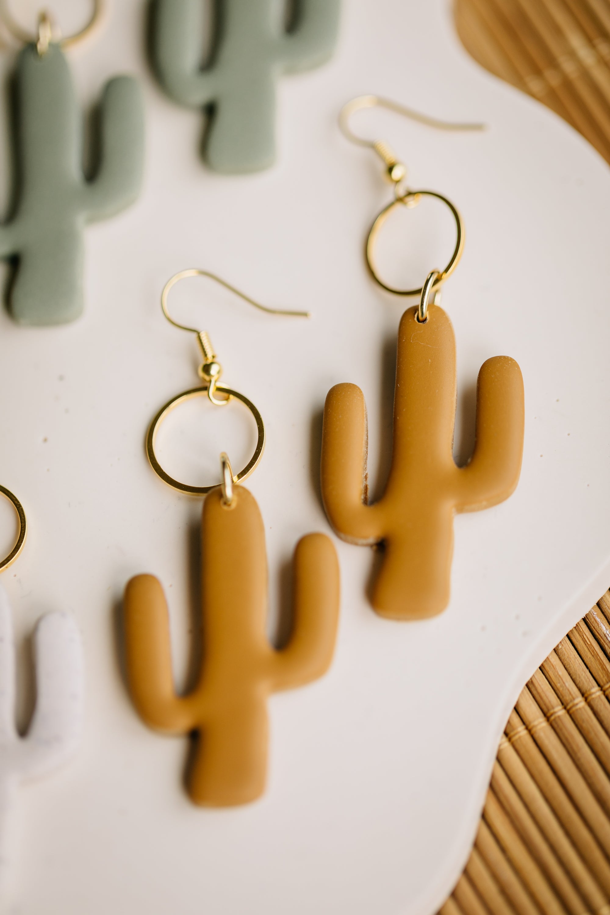 golden earrings with acrylic in white, petrol and brown