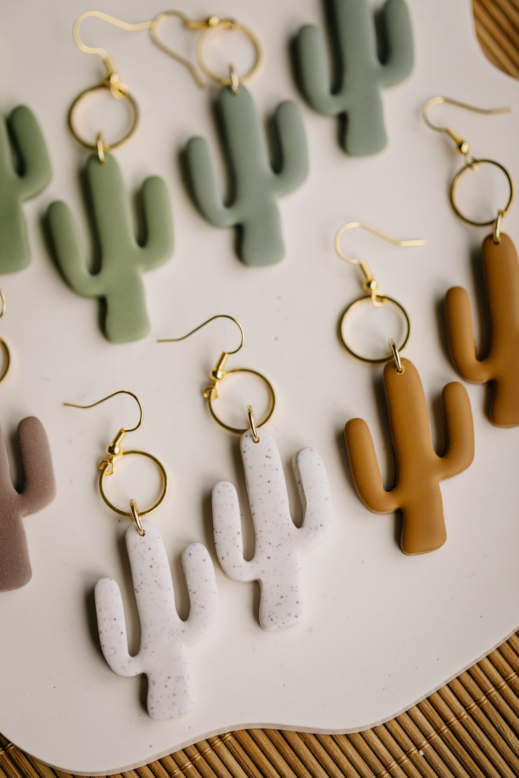golden earrings with acrylic in white, petrol and brown