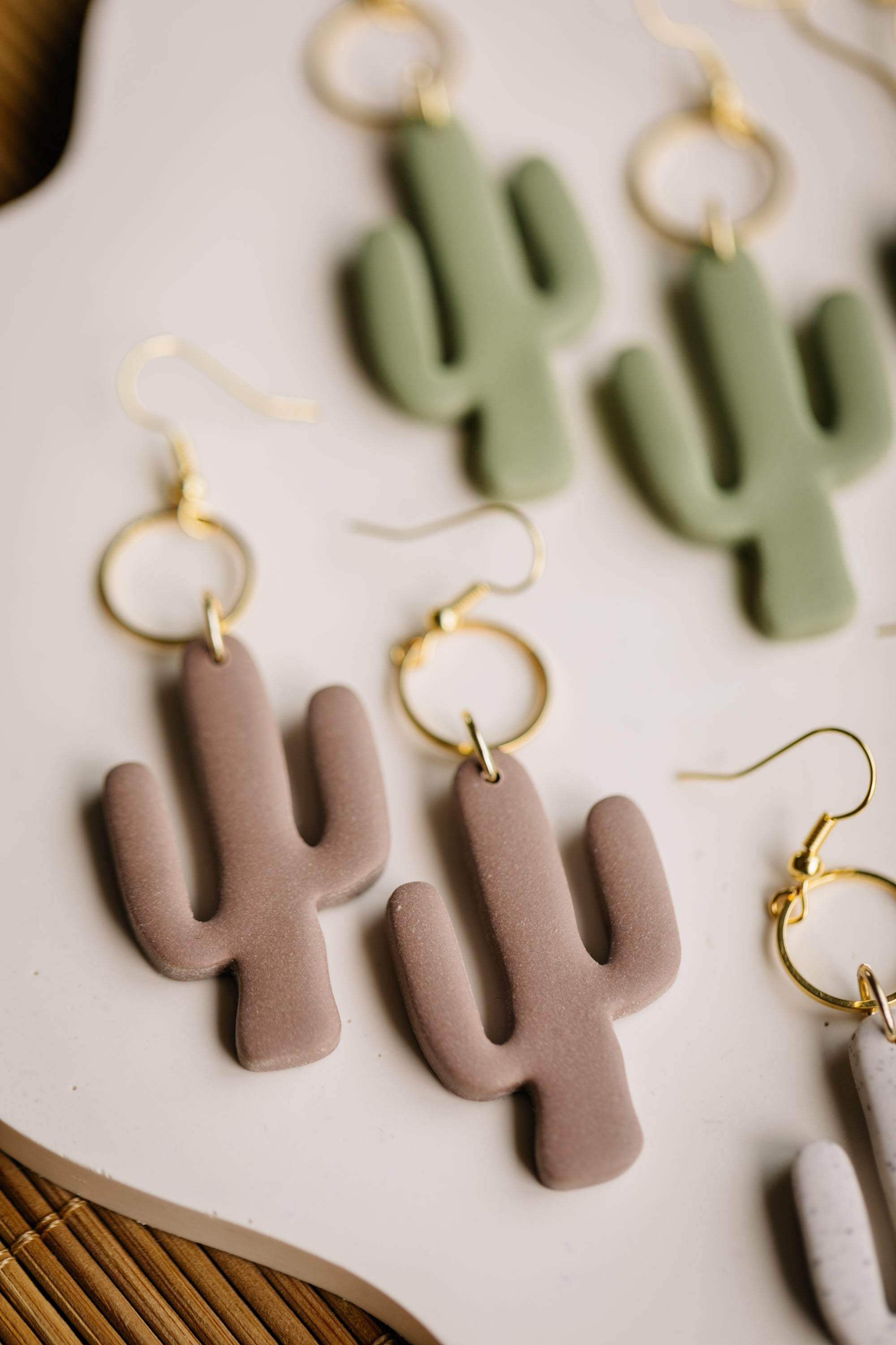 golden earrings with acrylic in white, petrol and brown