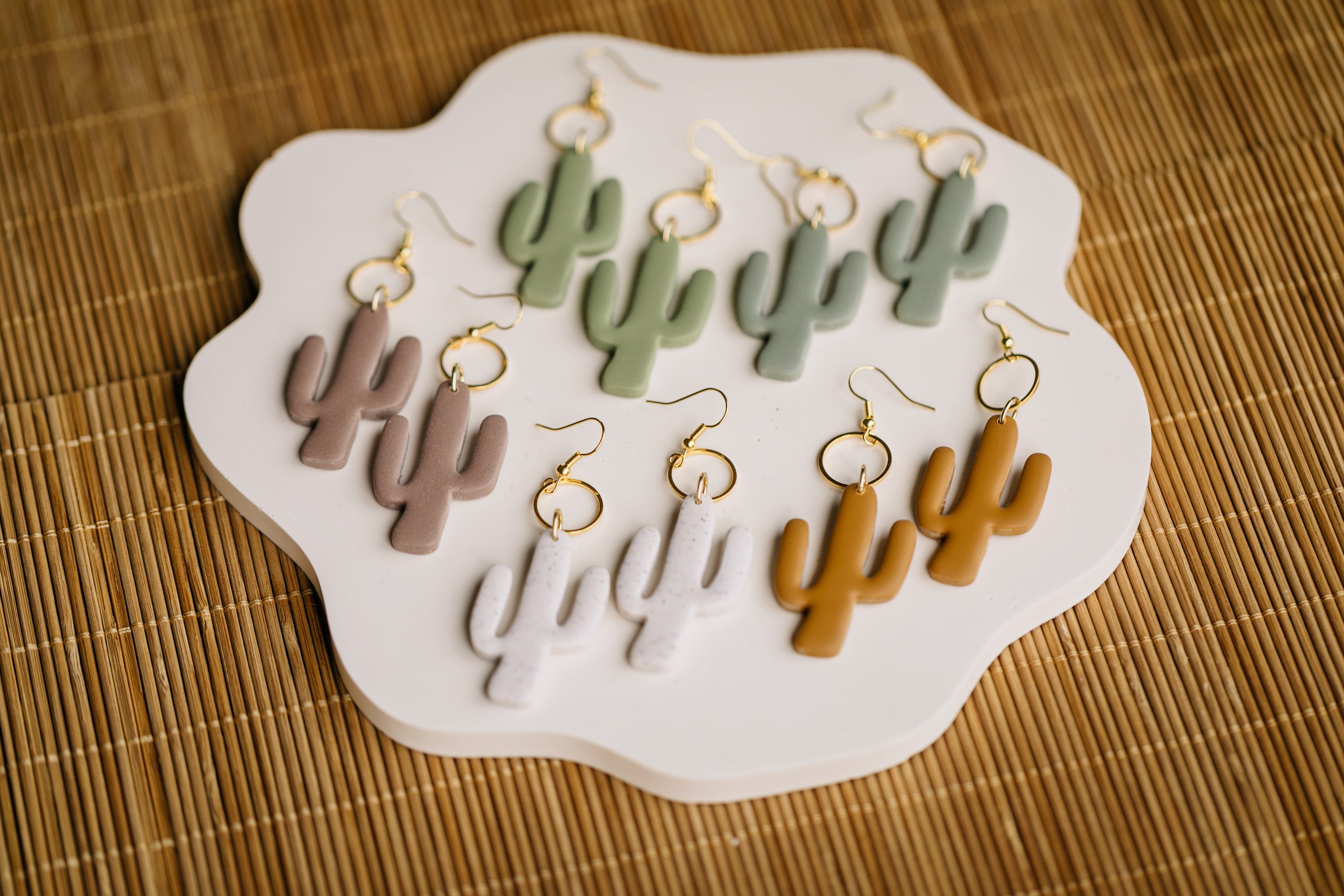 golden earrings with acrylic in white, petrol and brown