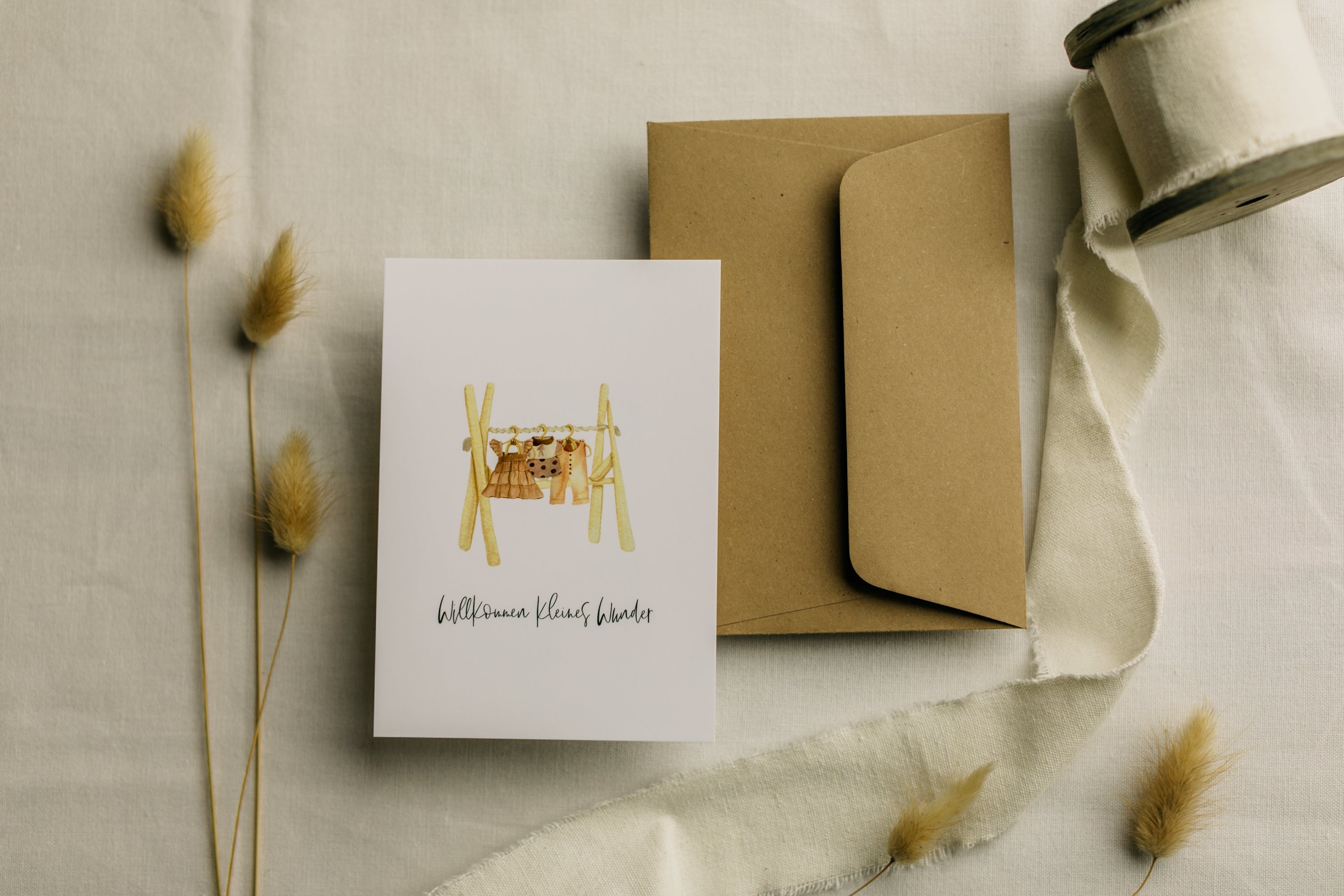 Postcard clothes rack with the print "Welcome little miracle"