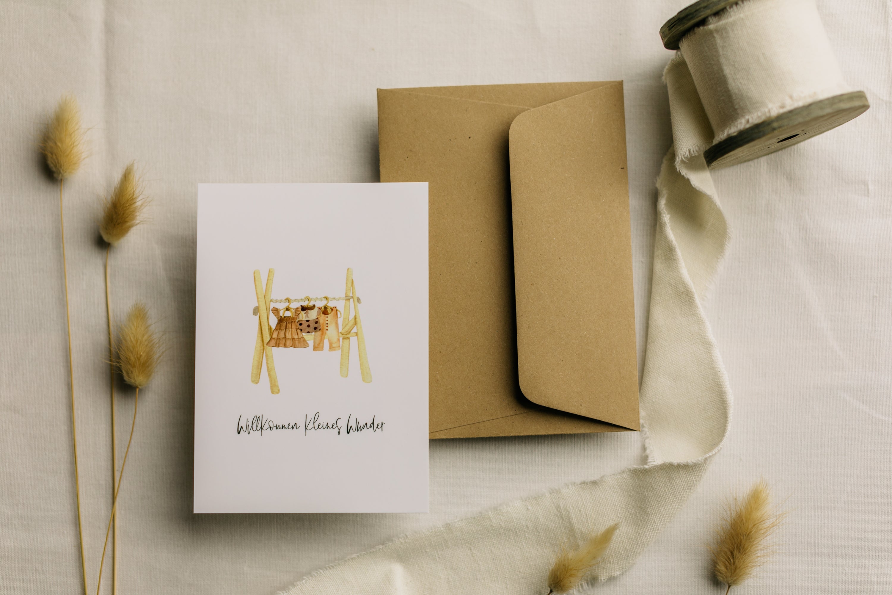 Postcard clothes rack with the print "Welcome little miracle"