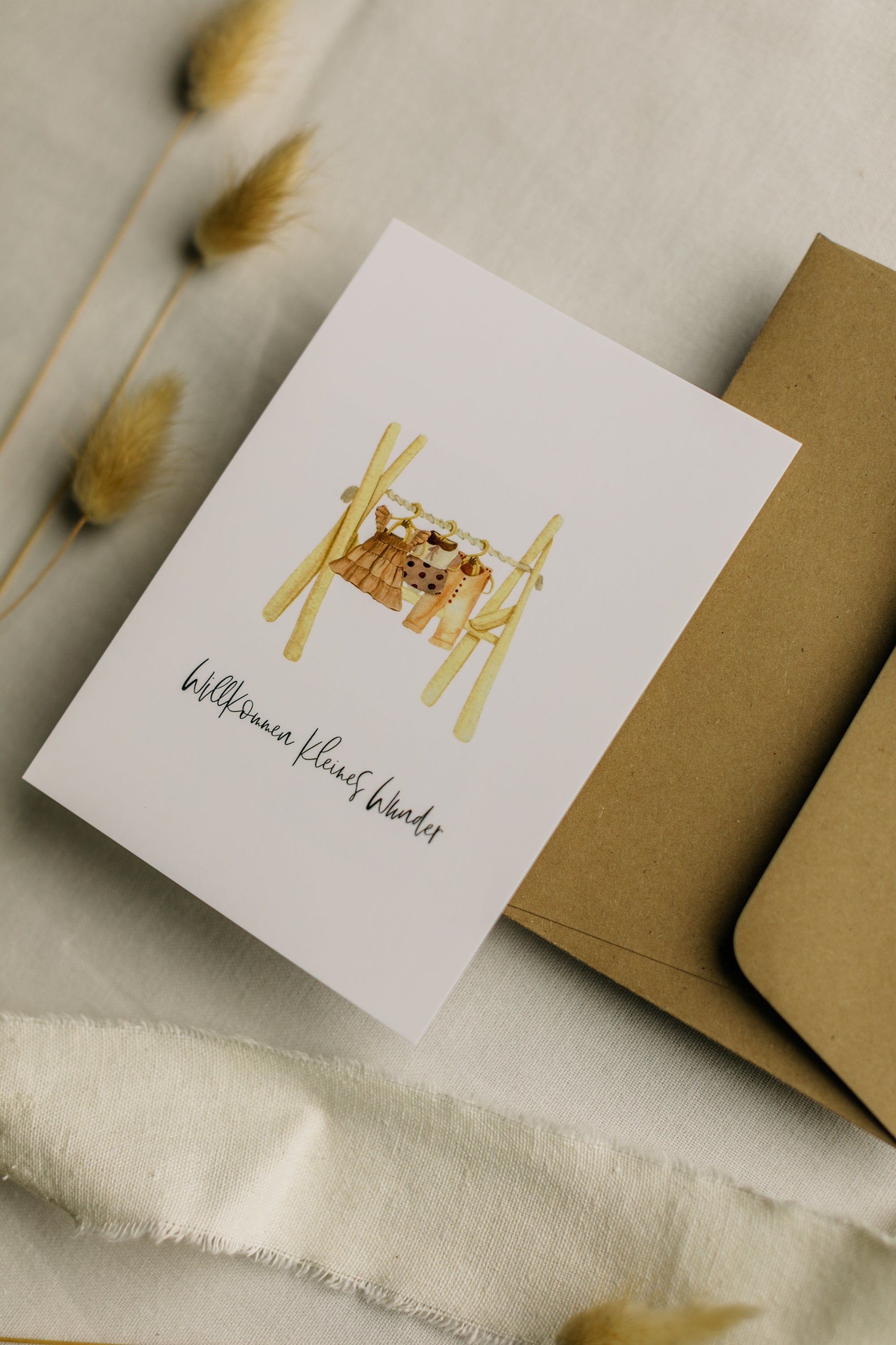 Postcard clothes rack with the print "Welcome little miracle"