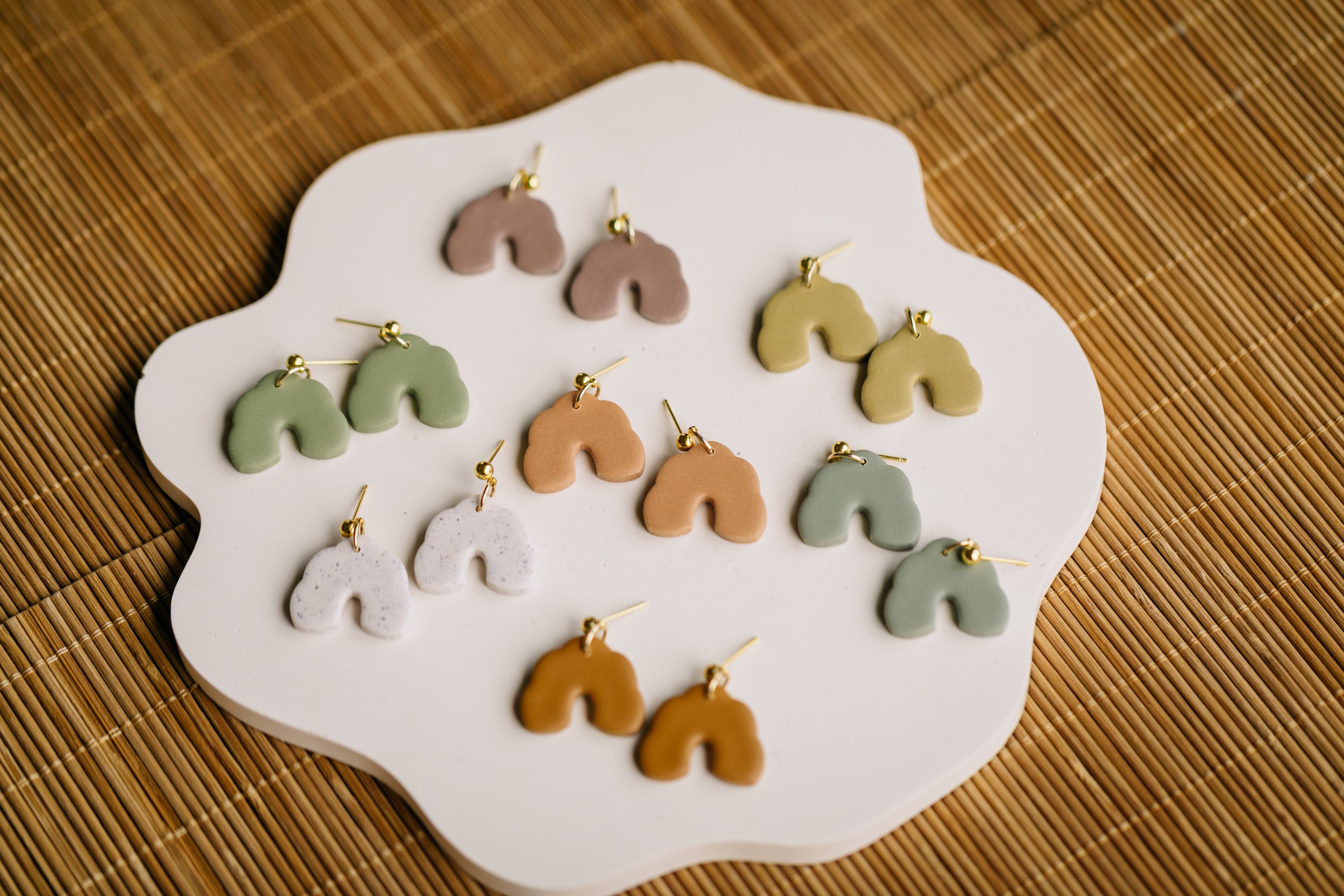 golden earrings with acrylic in white, petrol and brown