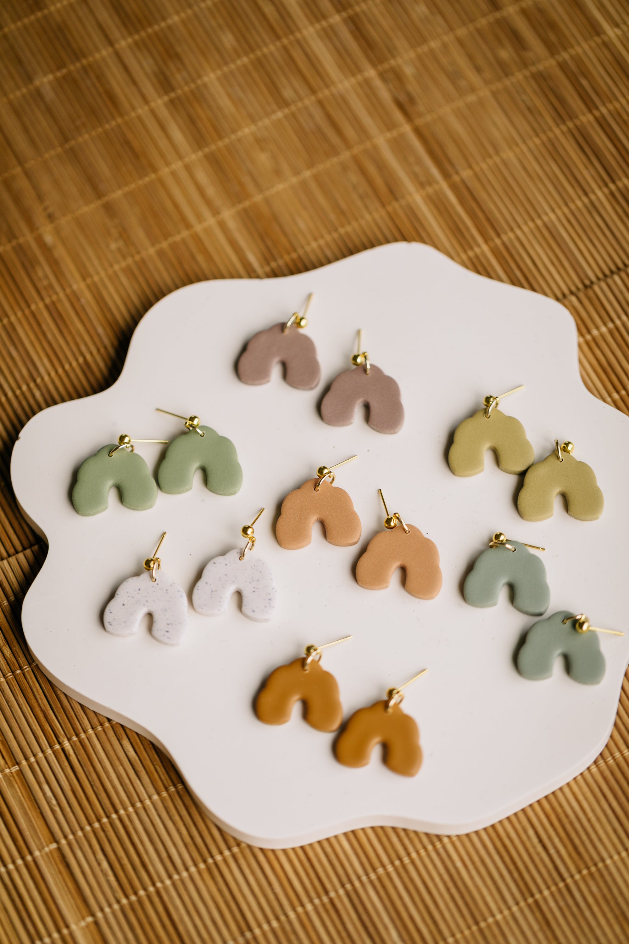 golden earrings with acrylic in white, petrol and brown