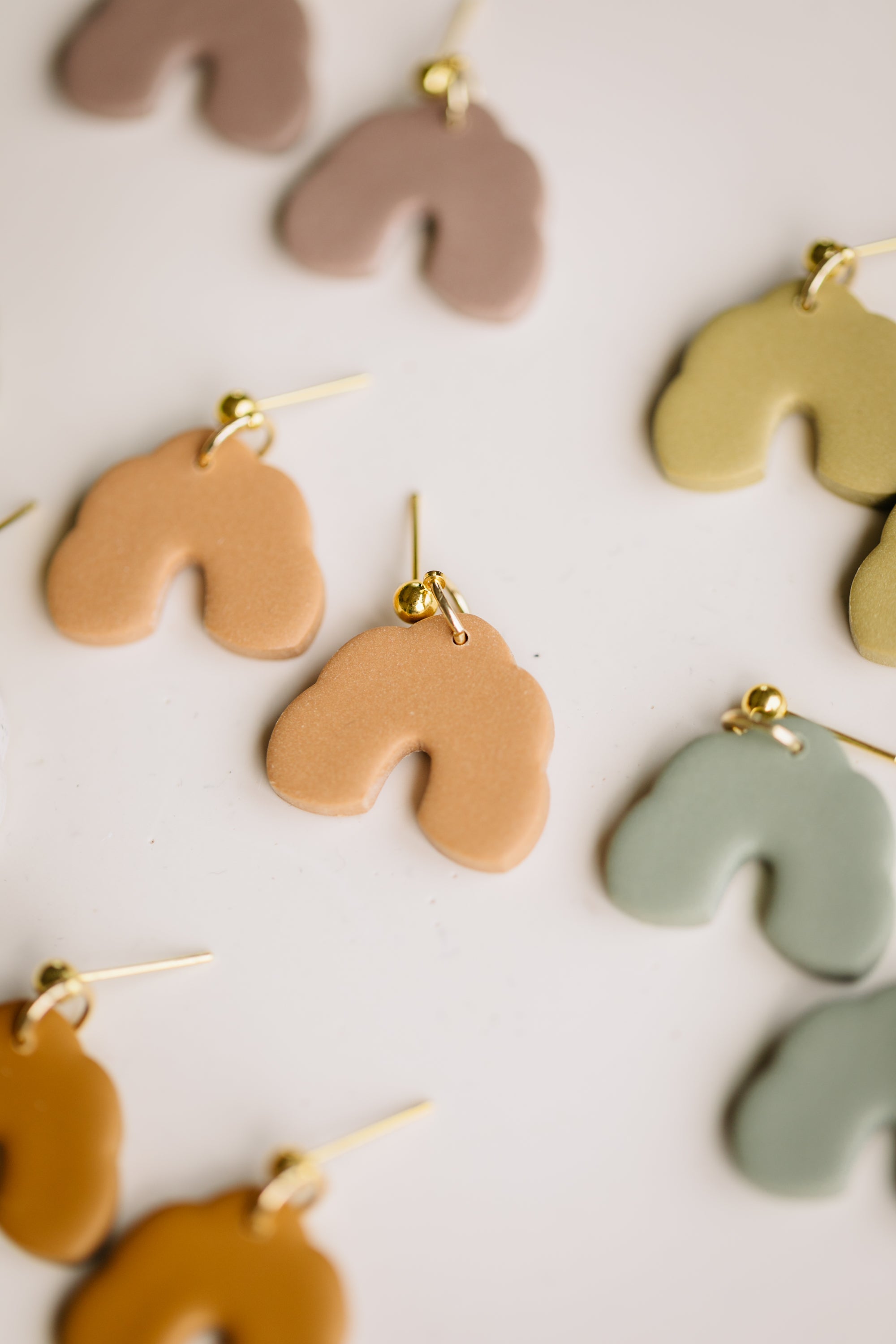 golden earrings with acrylic in white, petrol and brown