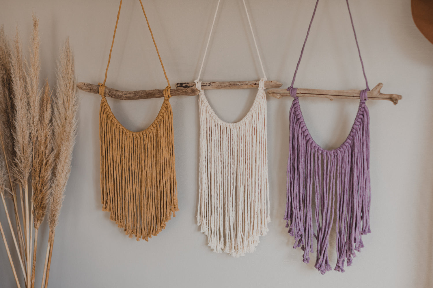 Macrame wall hanging in natural, yellow and purple colors