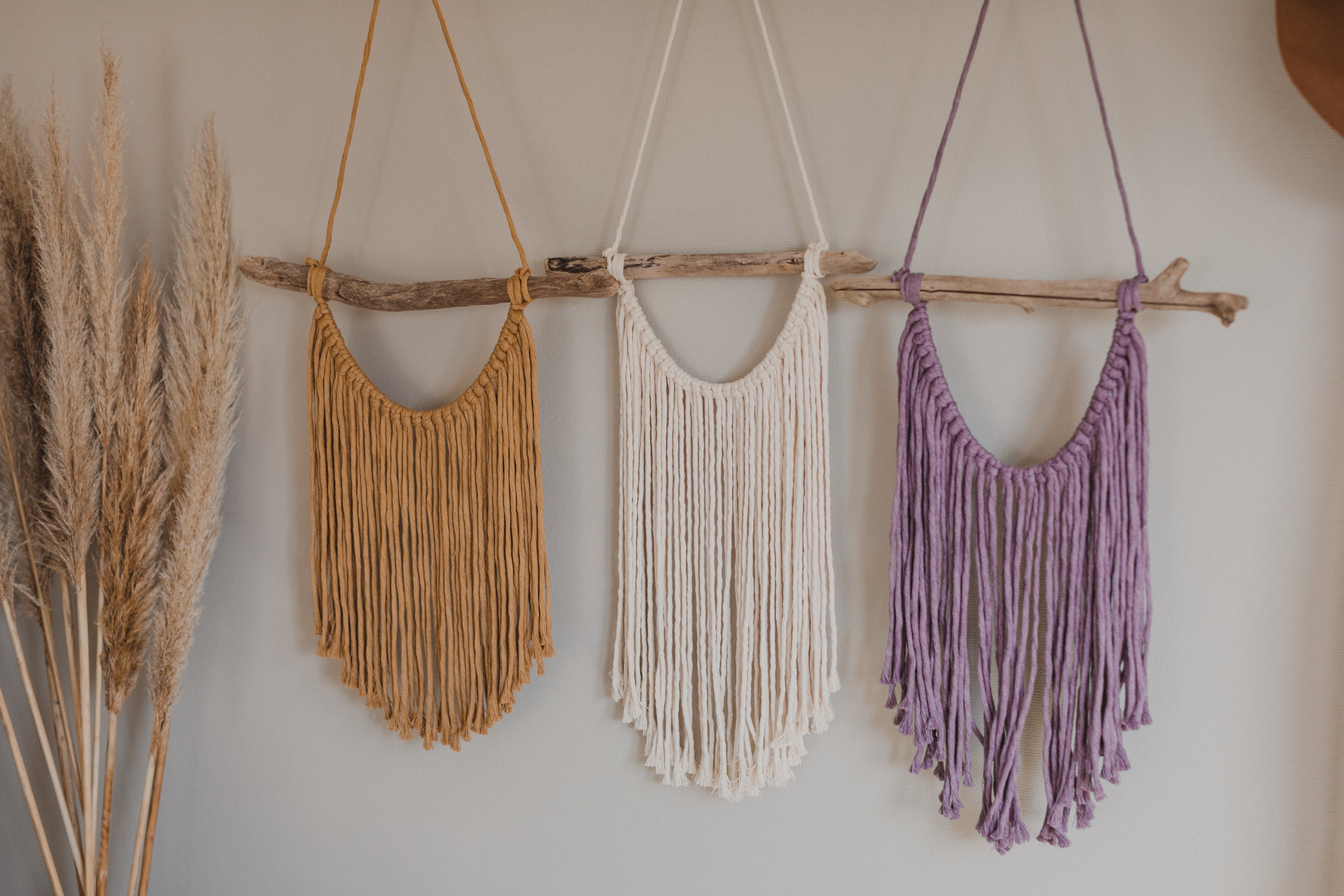 Macrame wall hanging in natural, yellow and purple colors