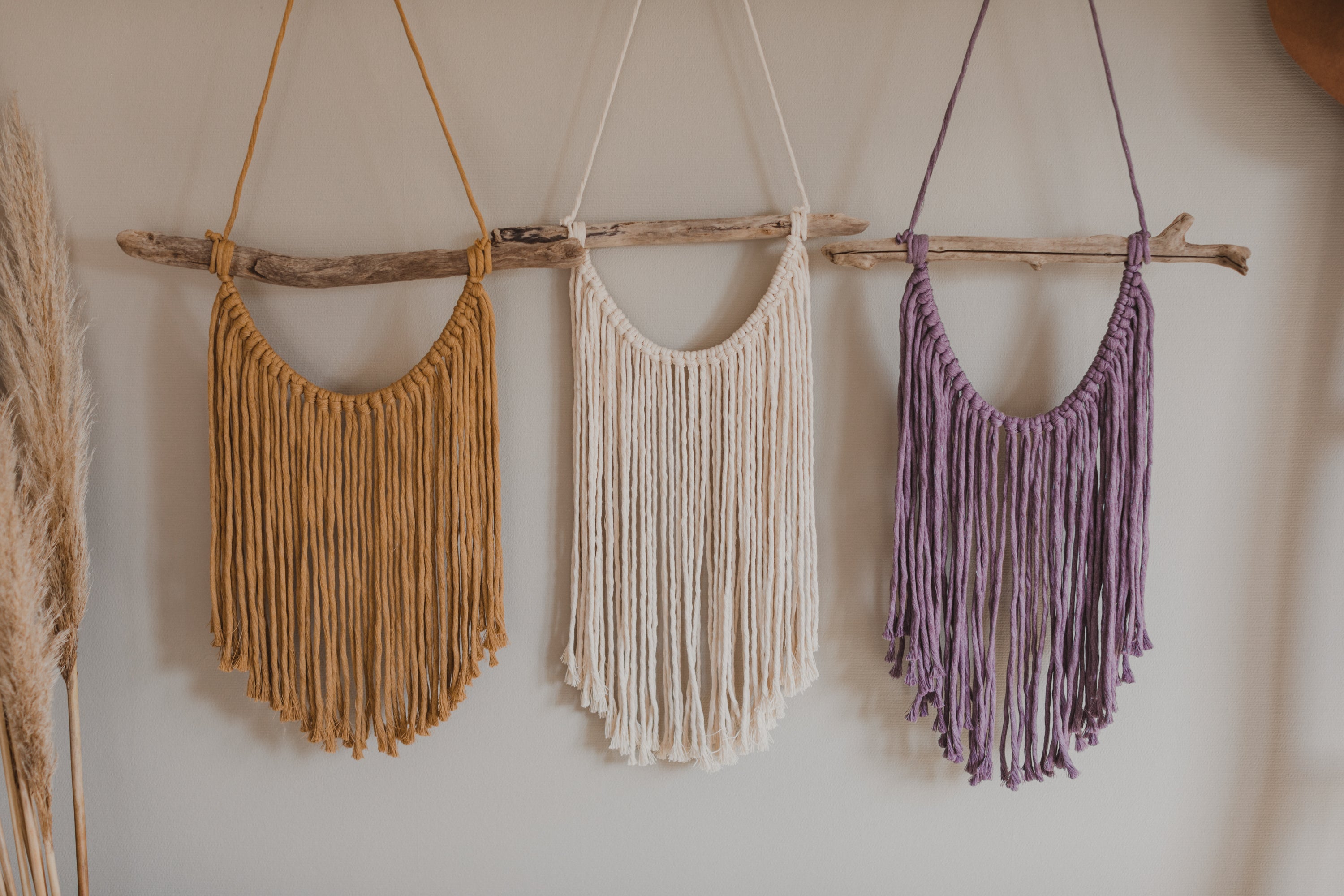 Macrame wall hanging in natural, yellow and purple colors