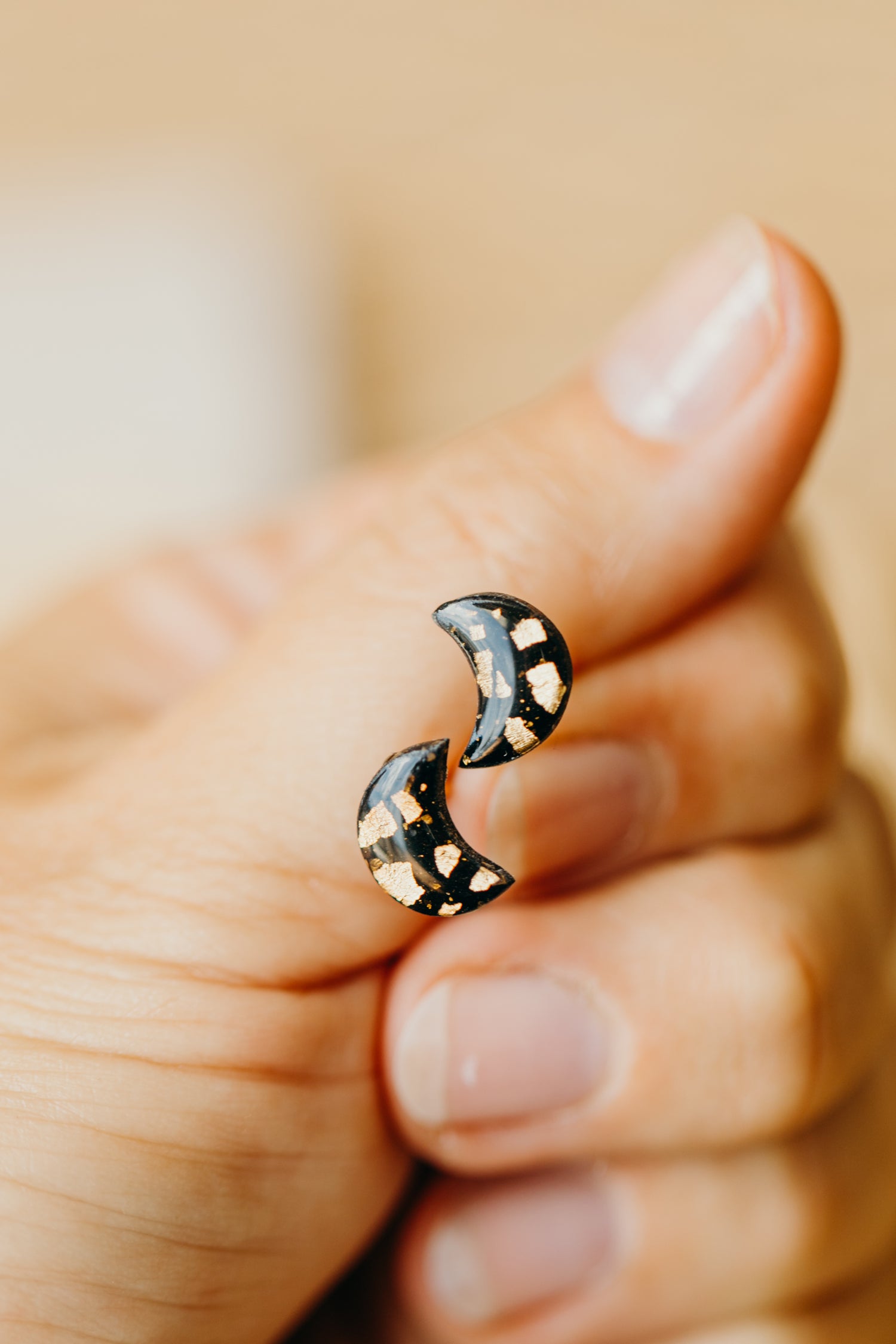 small moon earrings made of polymer clay with gold leaf