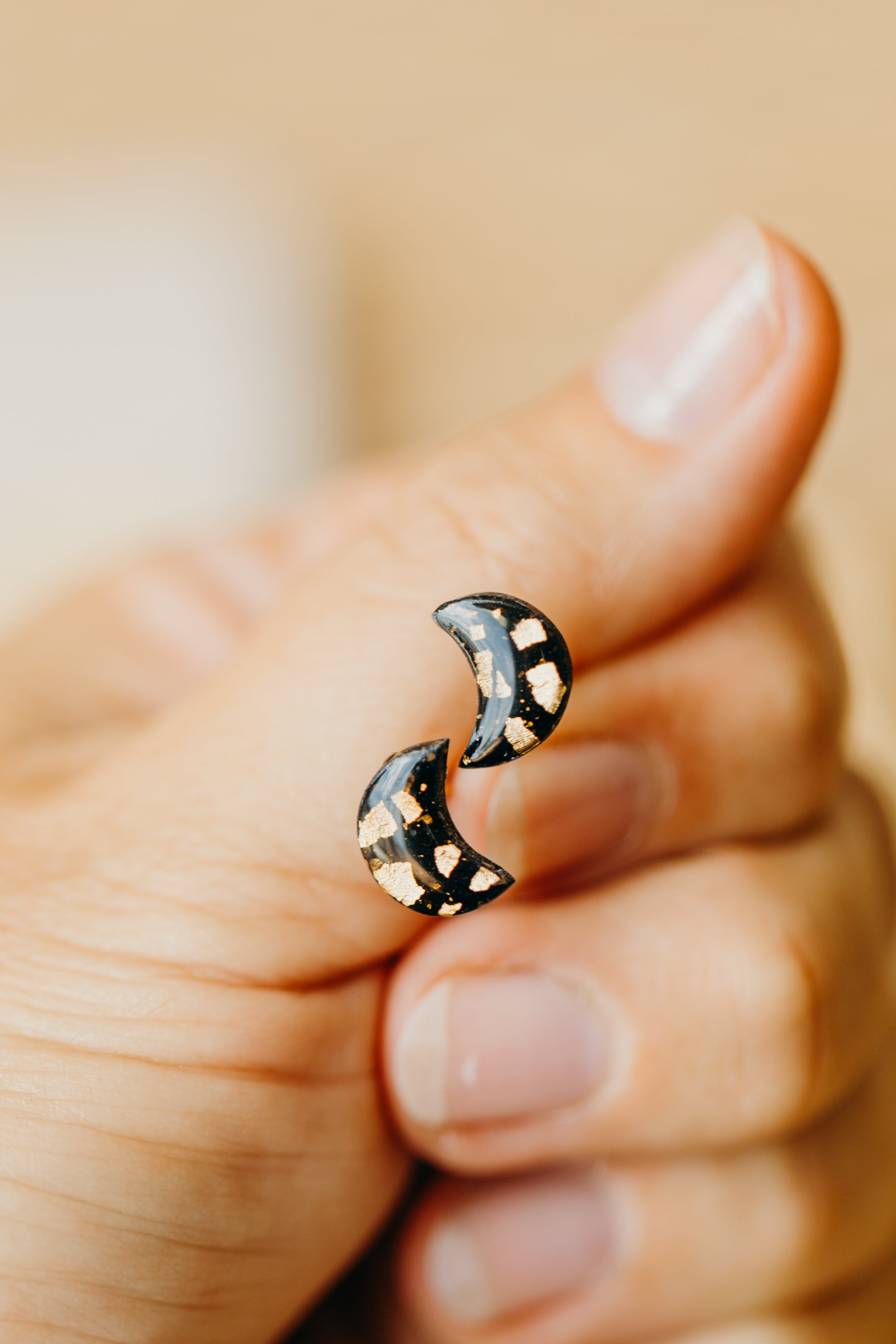 small moon earrings made of polymer clay with gold leaf