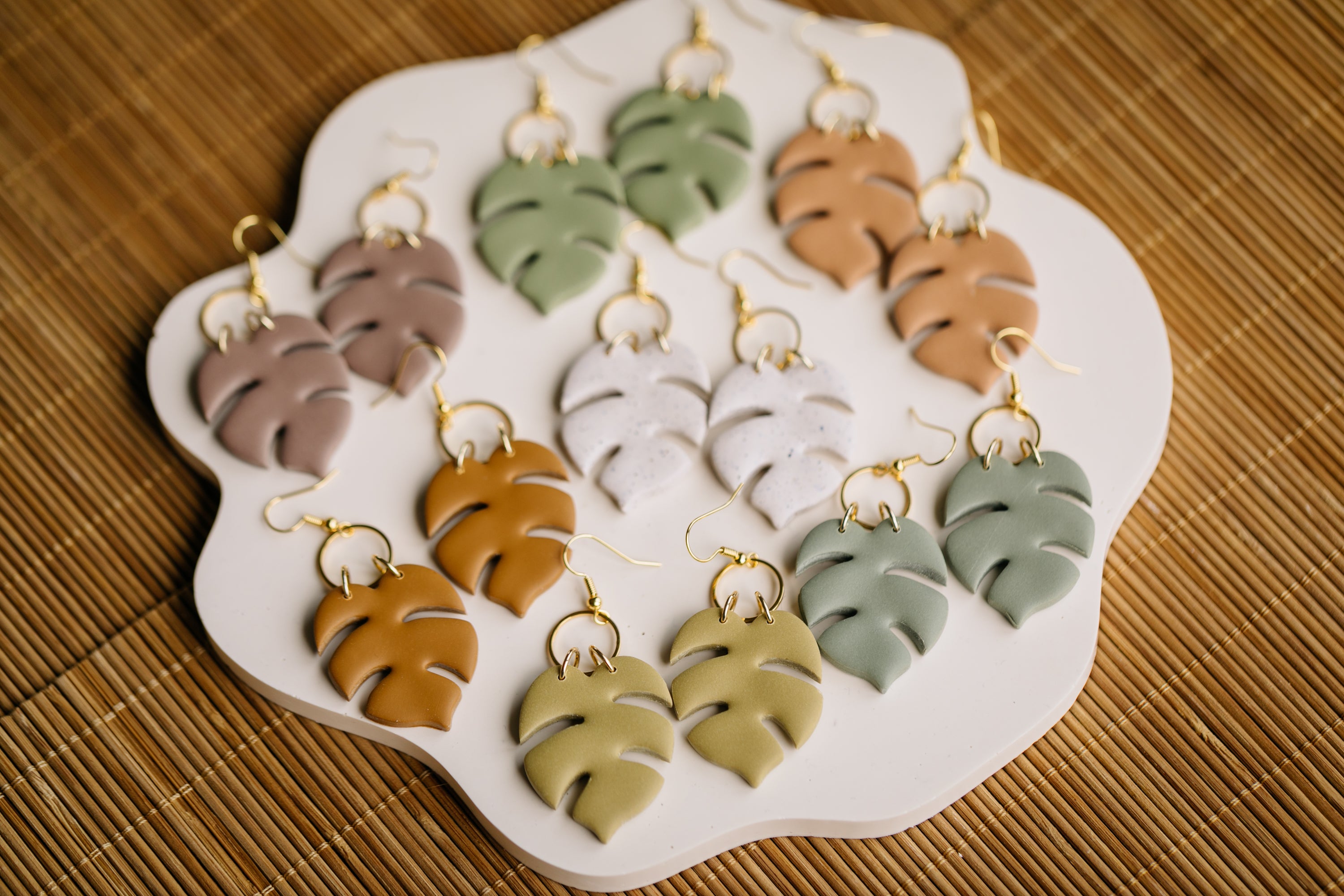 golden earrings with acrylic in white, petrol and brown