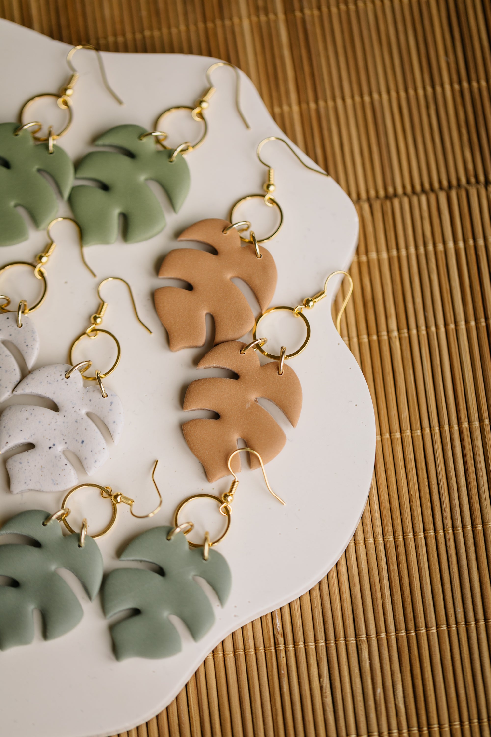 golden earrings with acrylic in white, petrol and brown