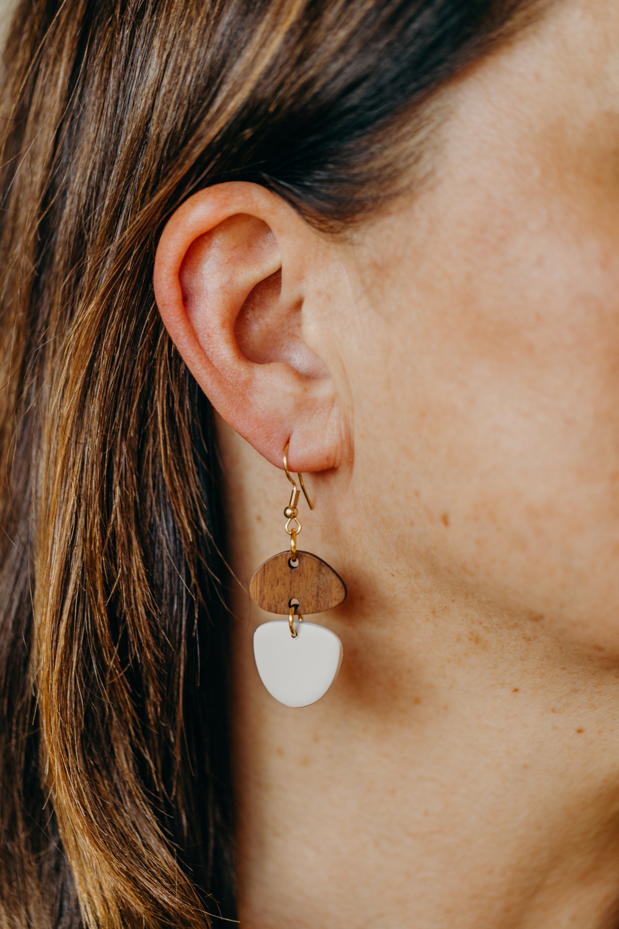 triangular polymer clay earrings in eucalyptus green with rectangular wooden pendant