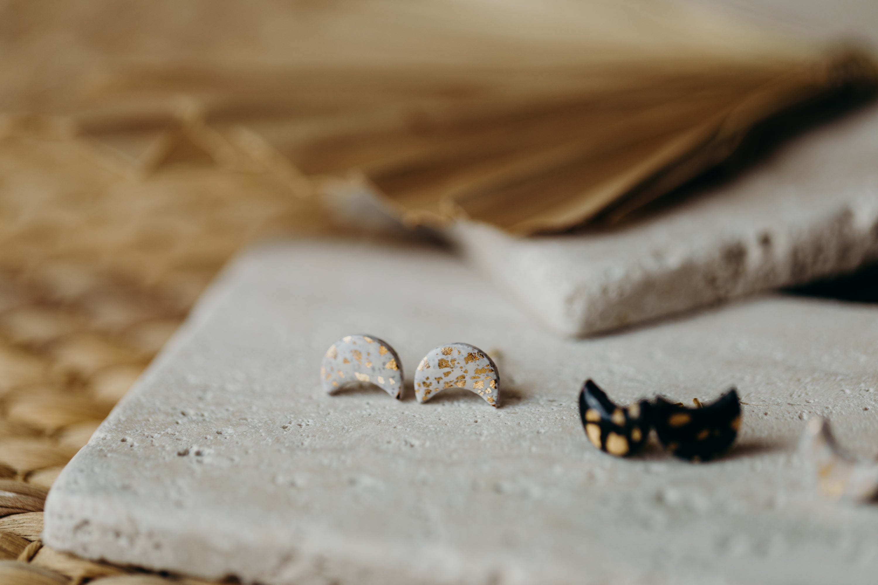 small moon earrings made of polymer clay with gold leaf