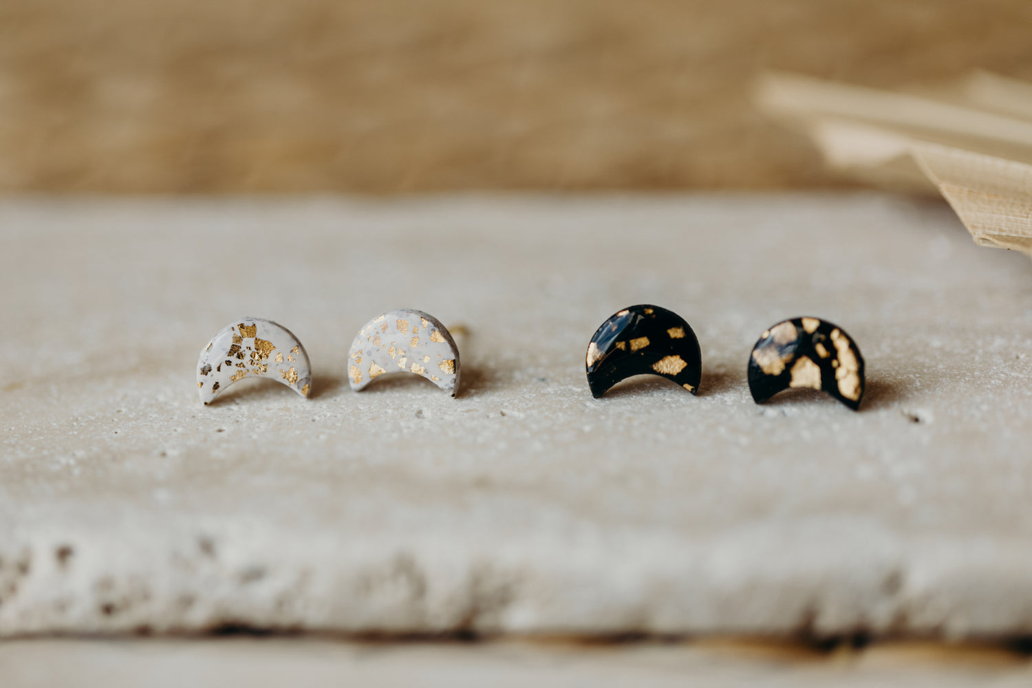 small moon earrings made of polymer clay with gold leaf