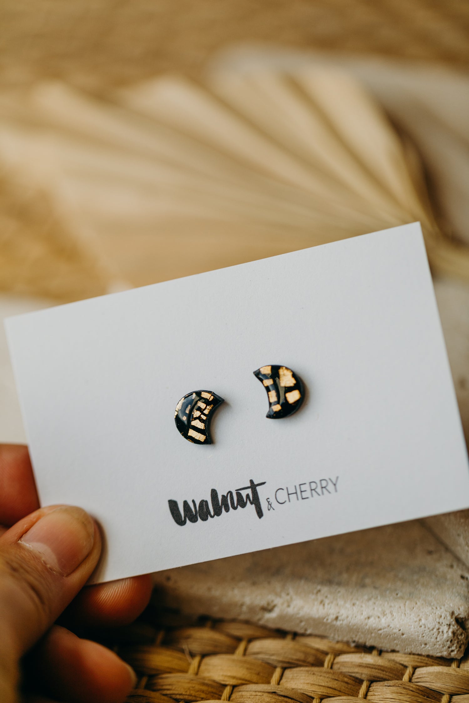 small moon earrings made of polymer clay with gold leaf