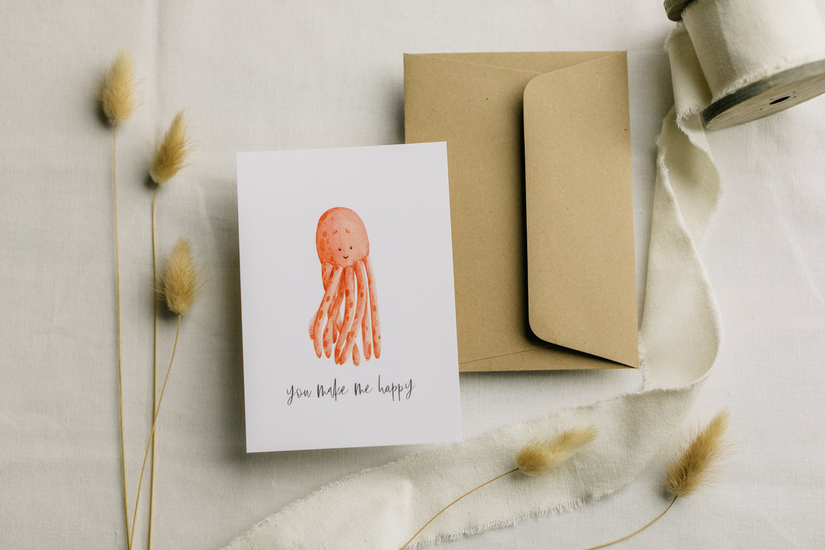 Postkarte roter Oktopus mit dem Aufdruck "you make me happy"