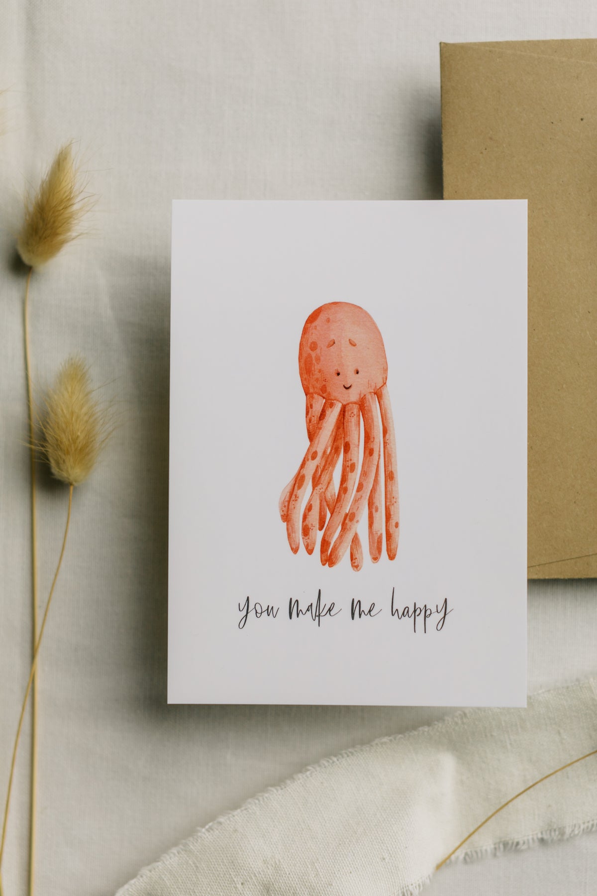 Postkarte roter Oktopus mit dem Aufdruck "you make me happy"