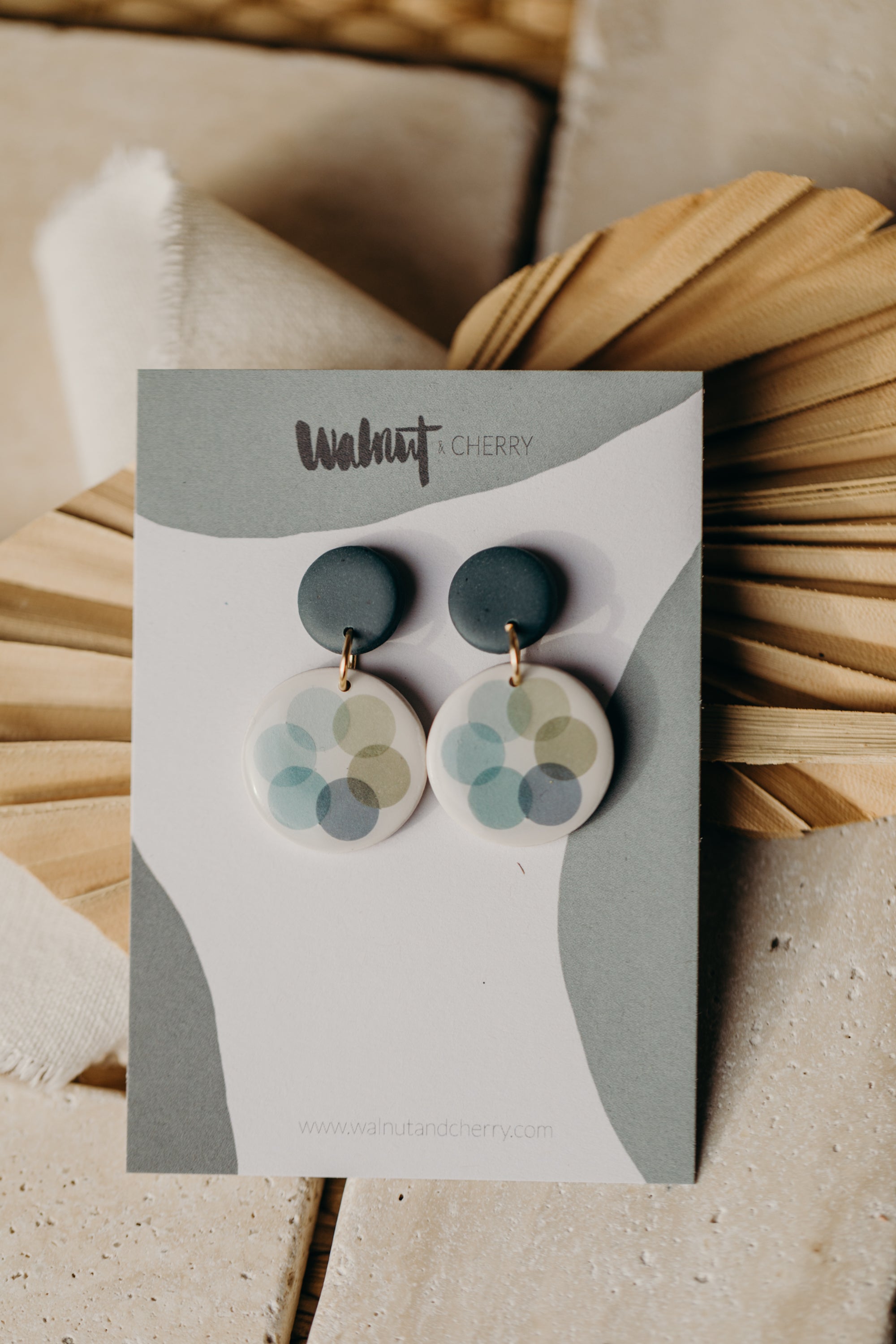MARLA - round dark blue polymer clay earrings with blue and green dots
