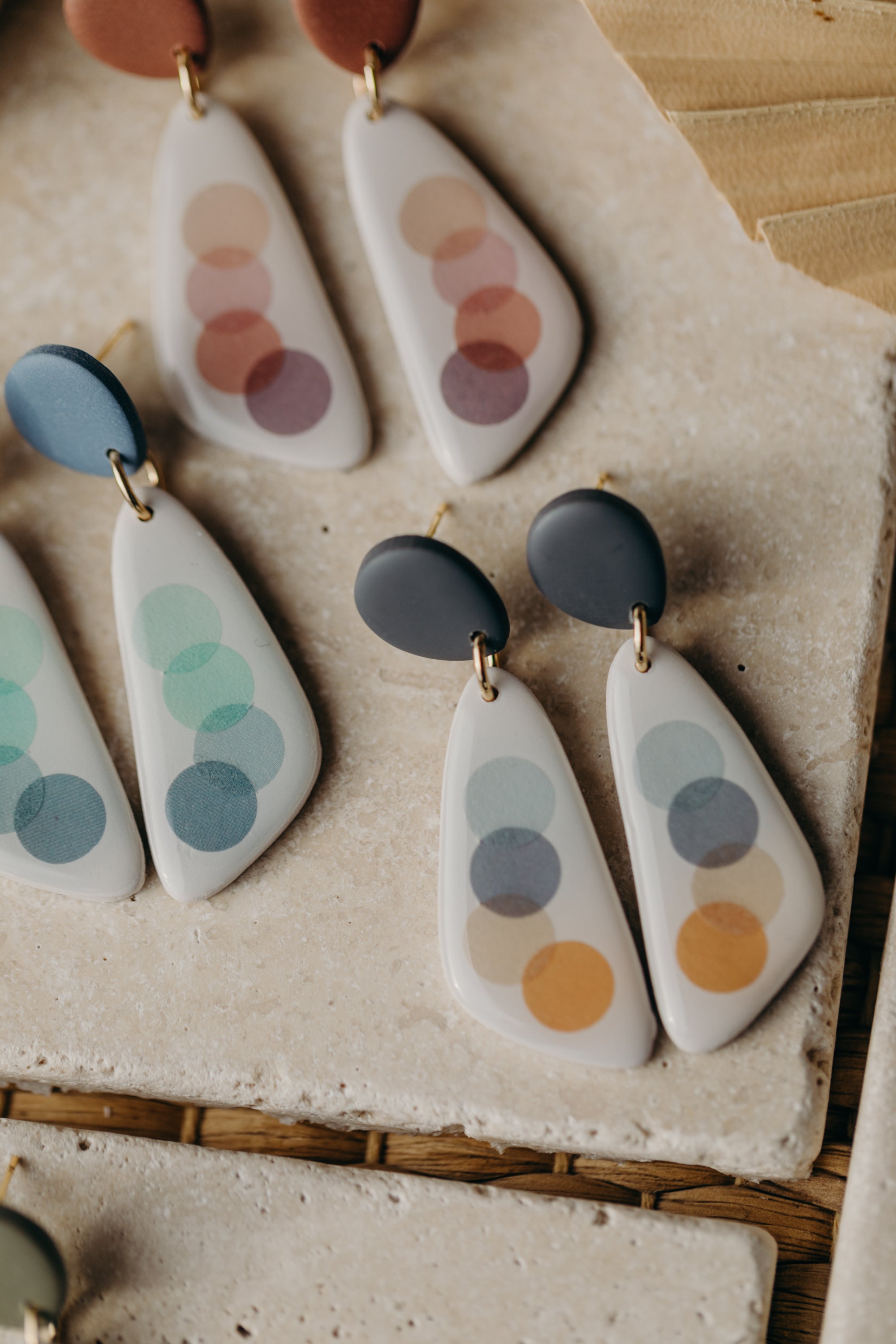 elongated blue-grey polymer clay earrings with blue and orange dots