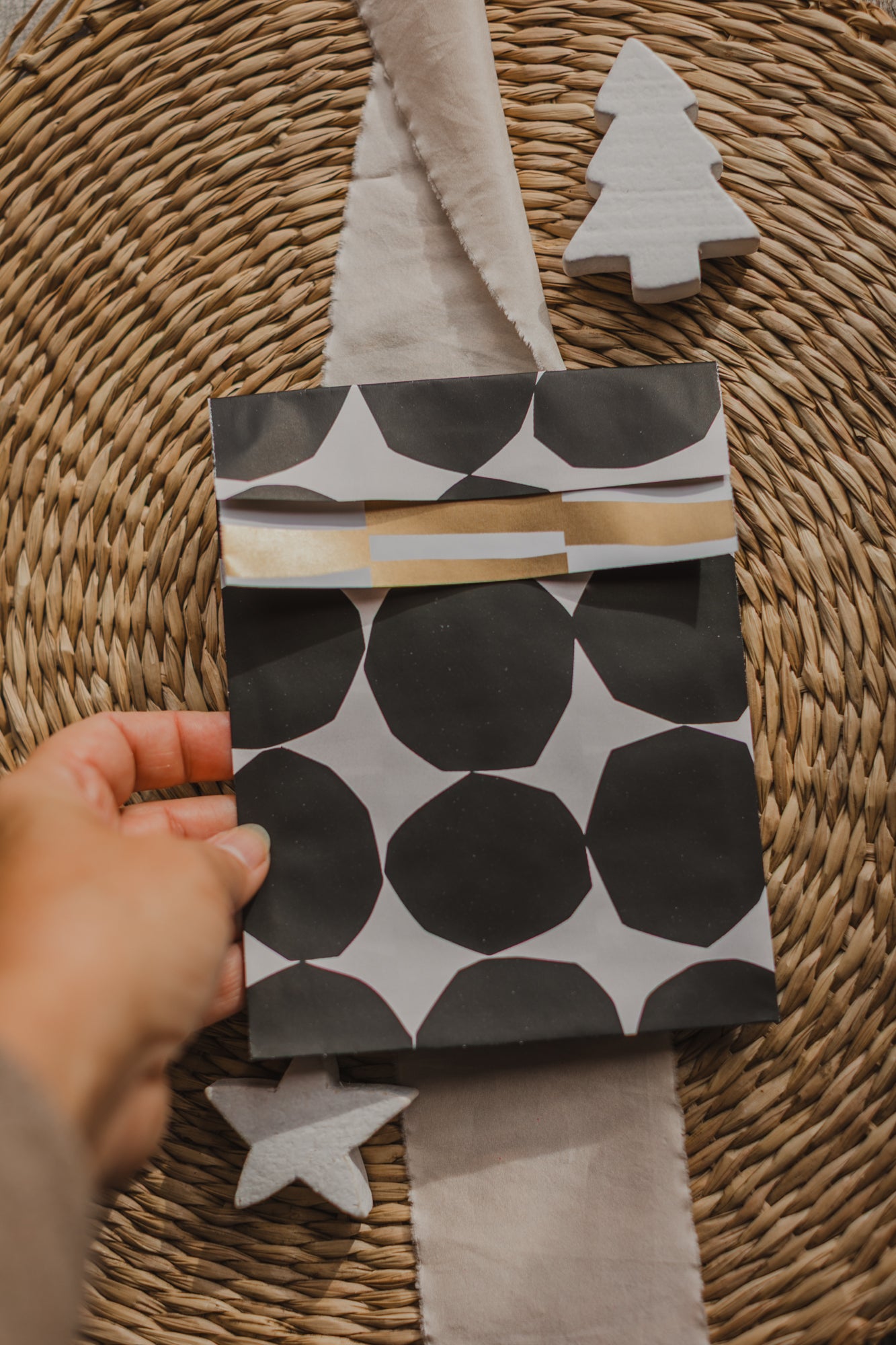 large paper bag with a small bird and branches