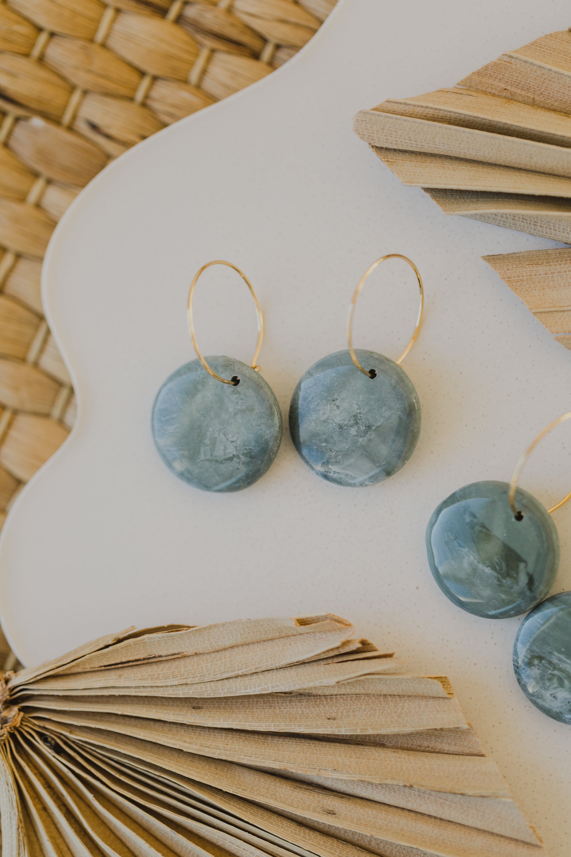 Hoop earrings with round polymer clay pendant and leaf