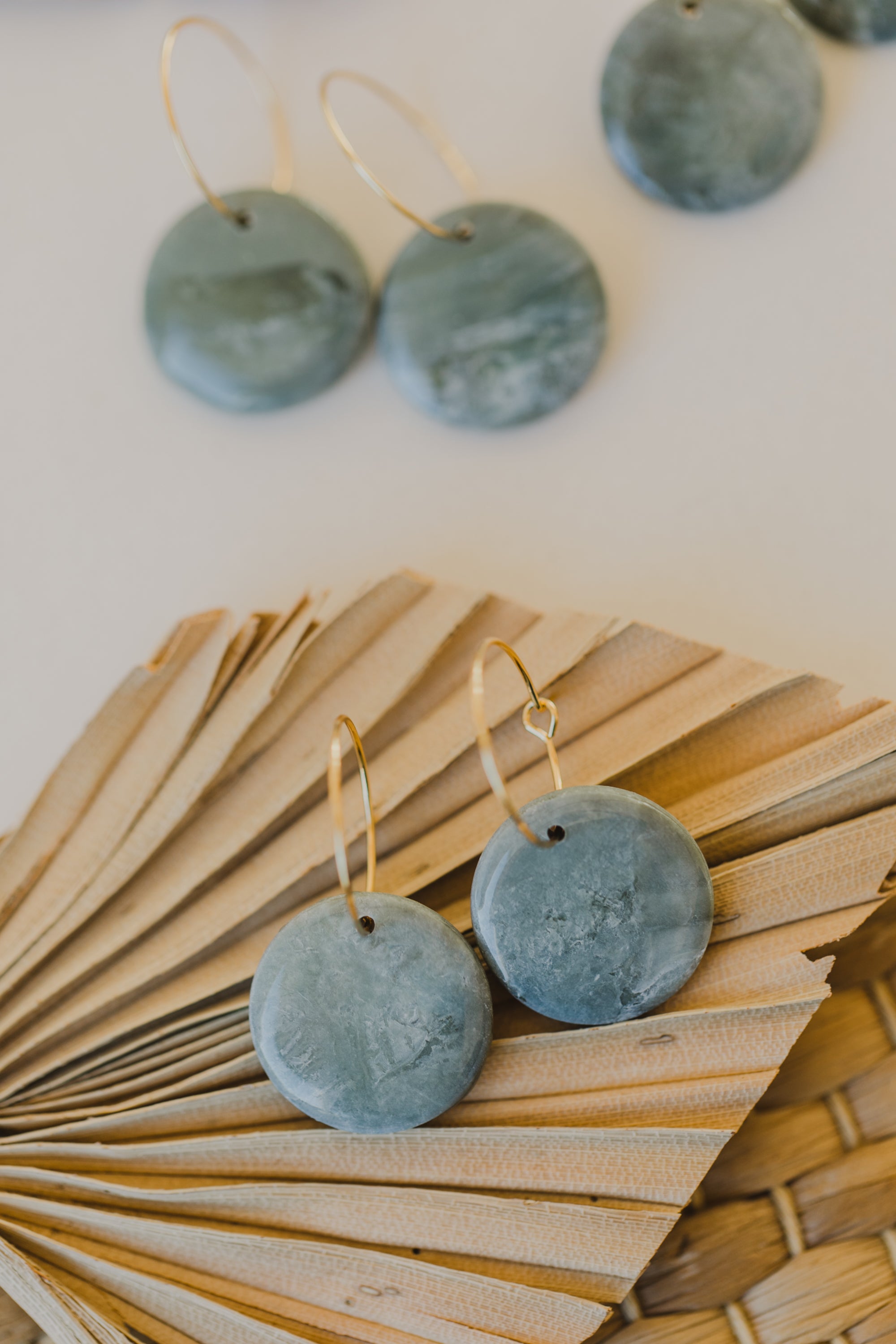 Hoop earrings with round polymer clay pendant and leaf