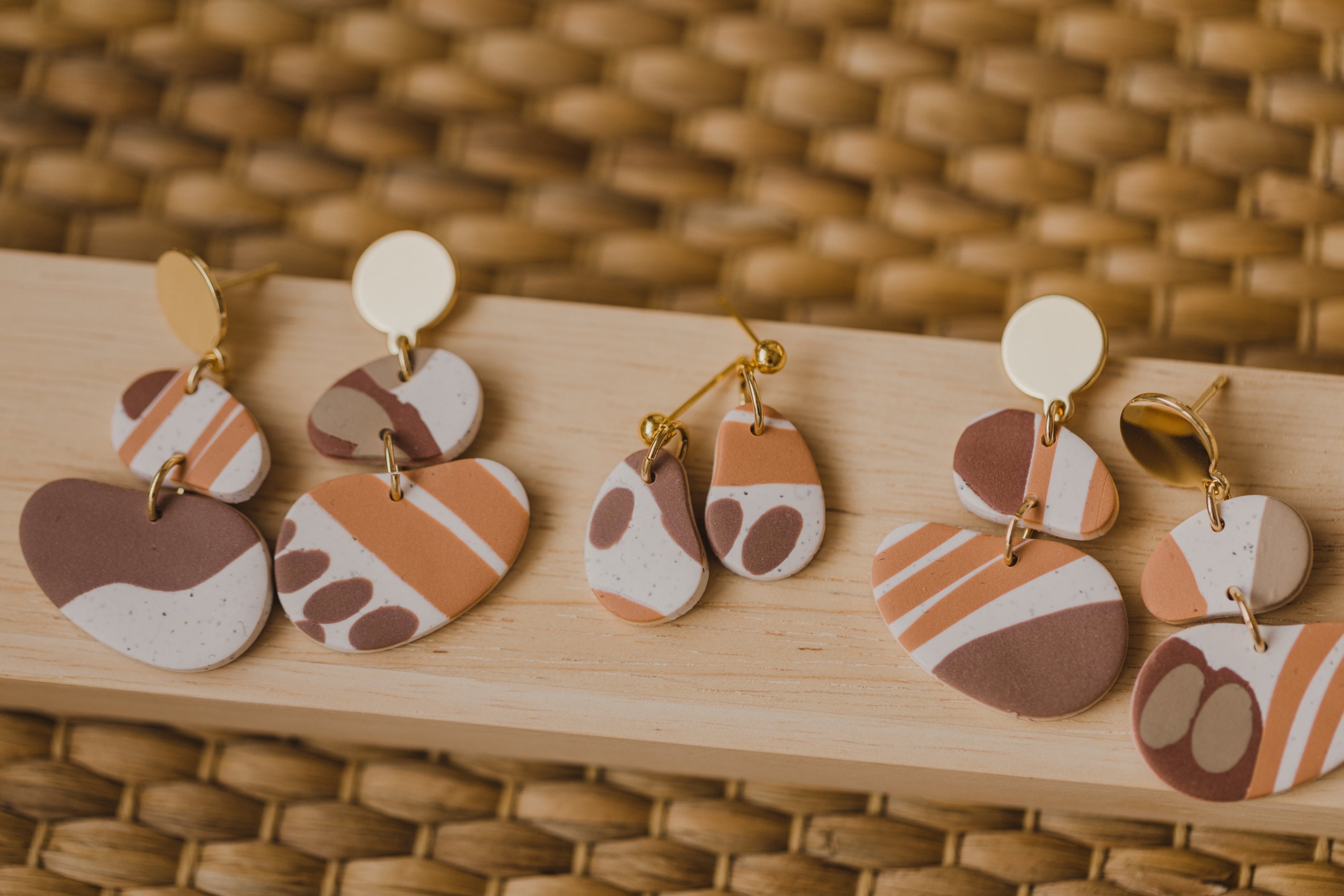 golden earrings with acrylic in white, petrol and brown